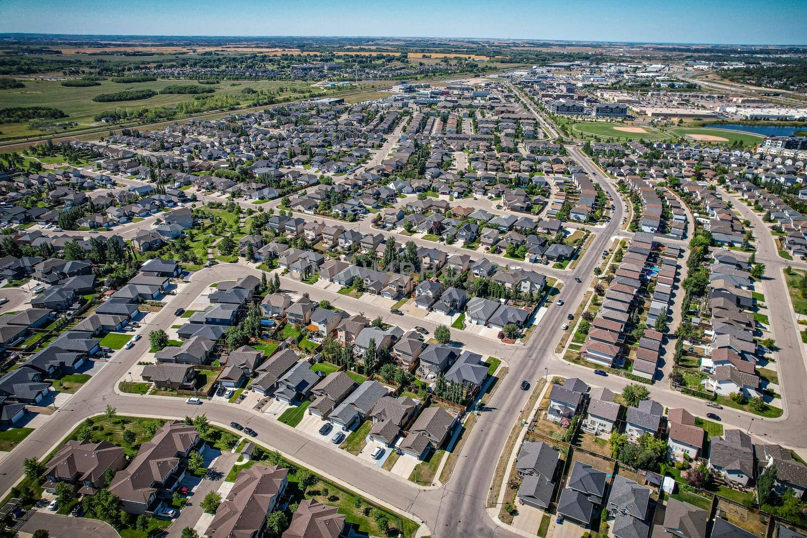 Captivating aerial shot of Stonebridge in Saskatoon, highlighting the harmonious blend of modern architecture and Saskatchewan's verdant surroundings.