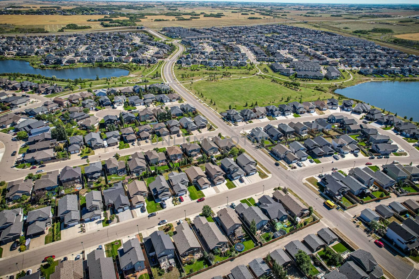Captivating aerial shot of Stonebridge in Saskatoon, highlighting the harmonious blend of modern architecture and Saskatchewan's verdant surroundings.
