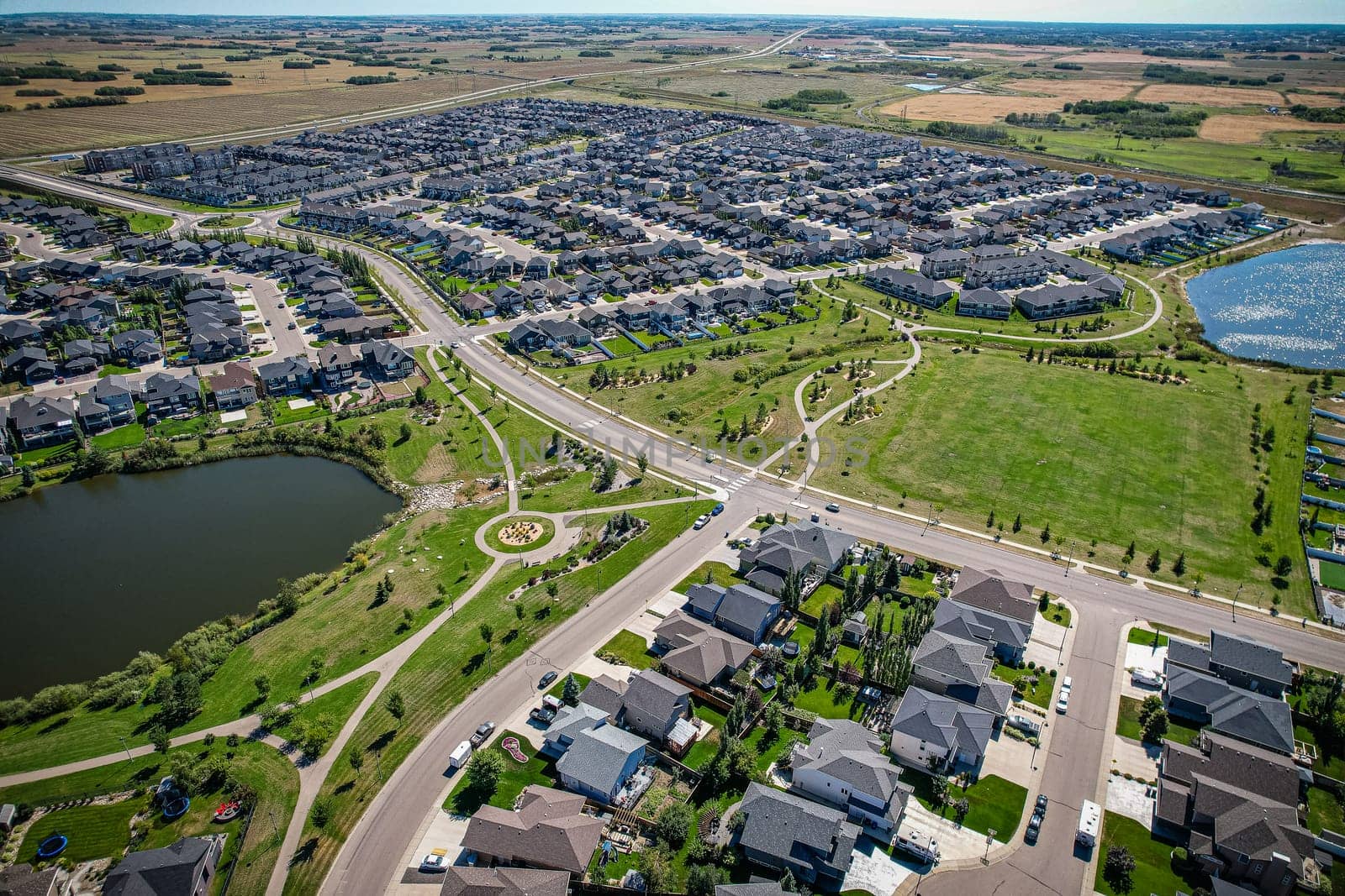 Captivating aerial shot of Stonebridge in Saskatoon, highlighting the harmonious blend of modern architecture and Saskatchewan's verdant surroundings.