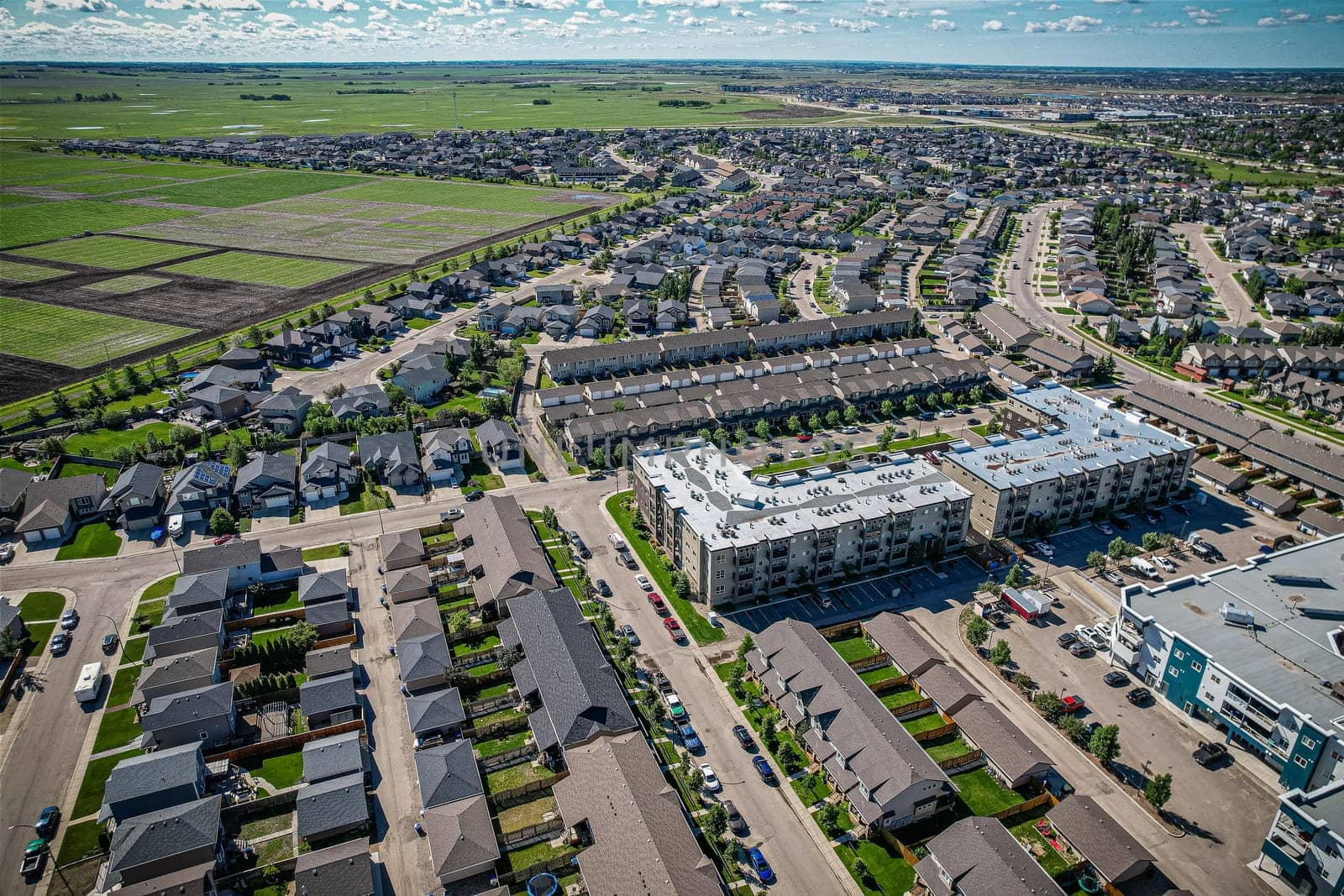 Elevated panorama of Willowgrove, showcasing the neighborhood's modern aesthetics intertwined with pockets of lush green, epitomizing Saskatoon's suburban beauty