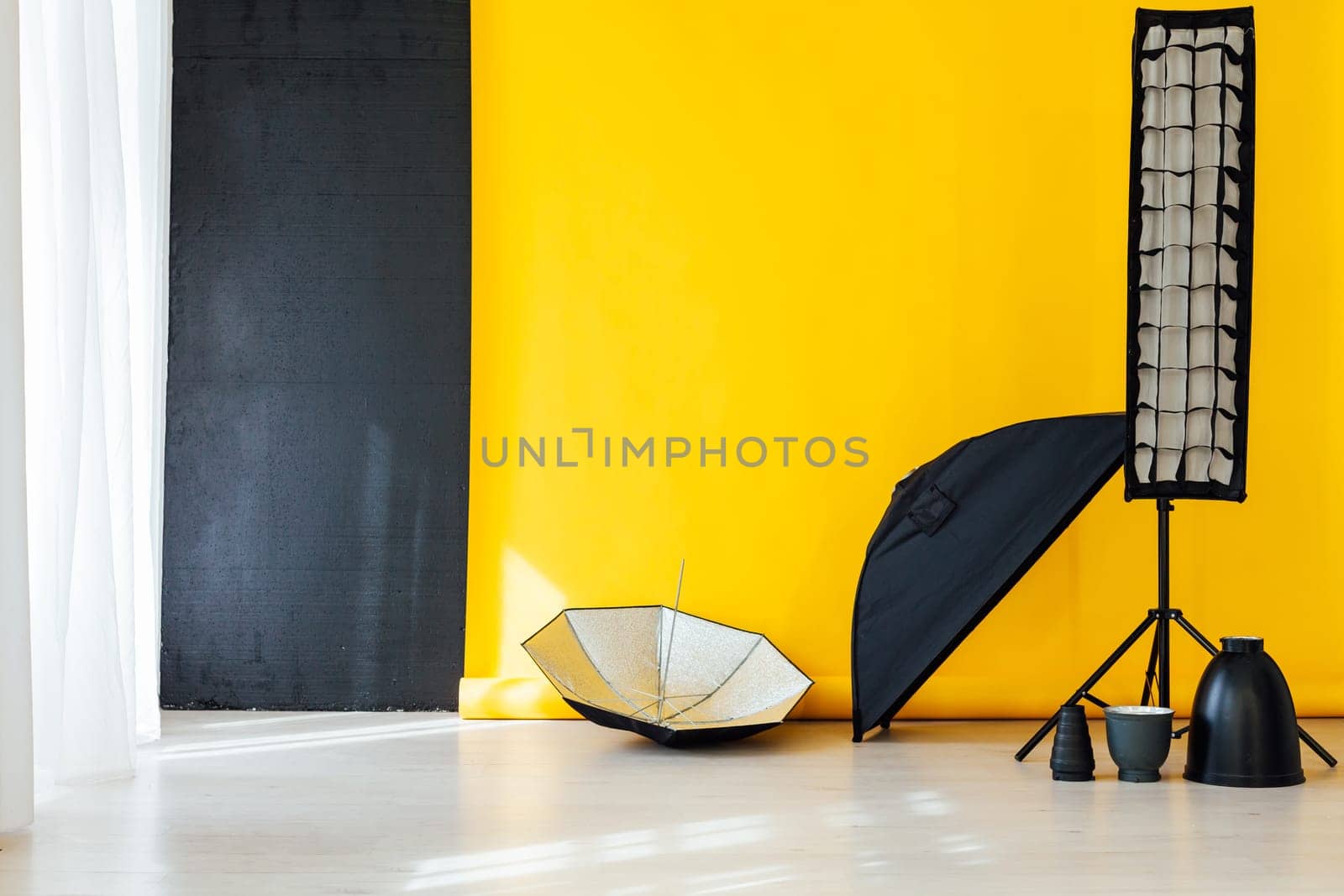 flash and accessories photo studio on a yellow background by Simakov