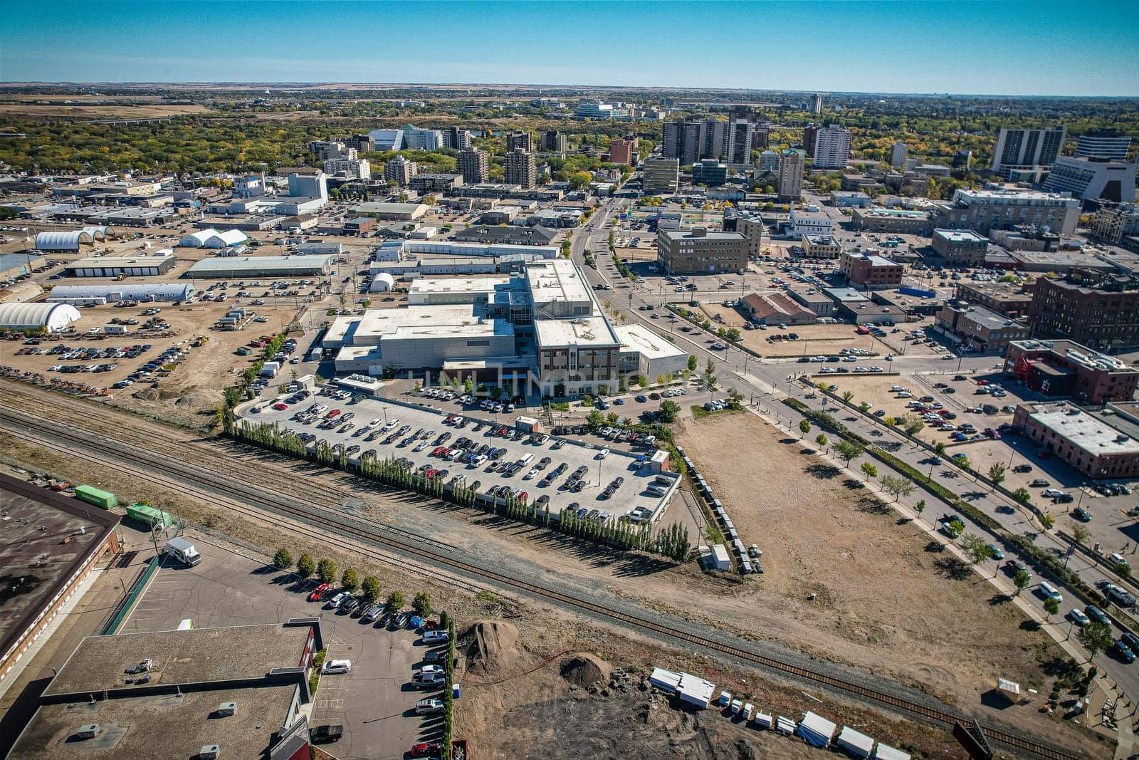 Aerial spectacle of downtown Saskatoon, revealing the city's architectural marvels, bustling streets, and the pulsating core of Saskatchewan's metropolis