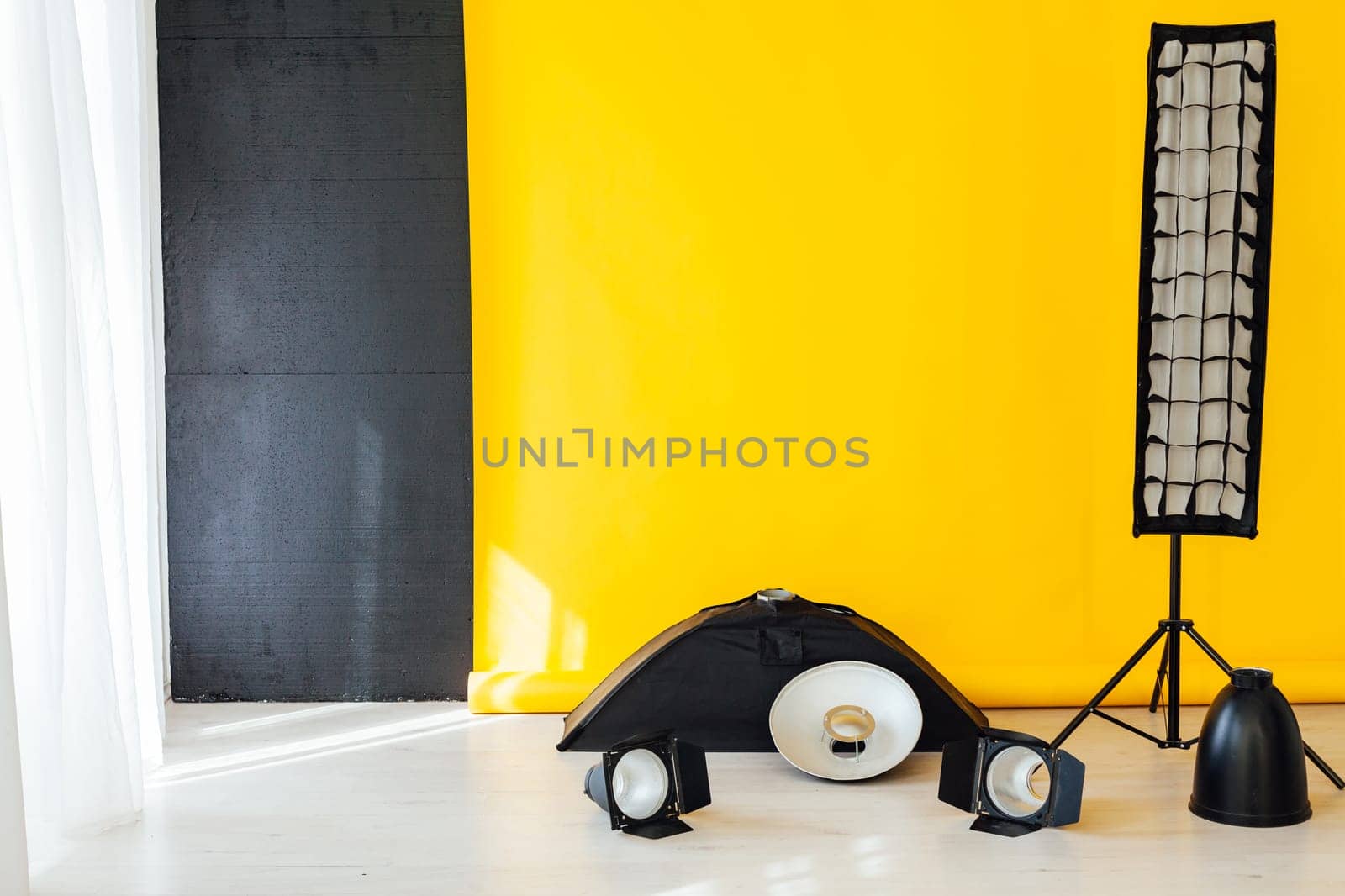 flash and accessories photo studio on a yellow background by Simakov
