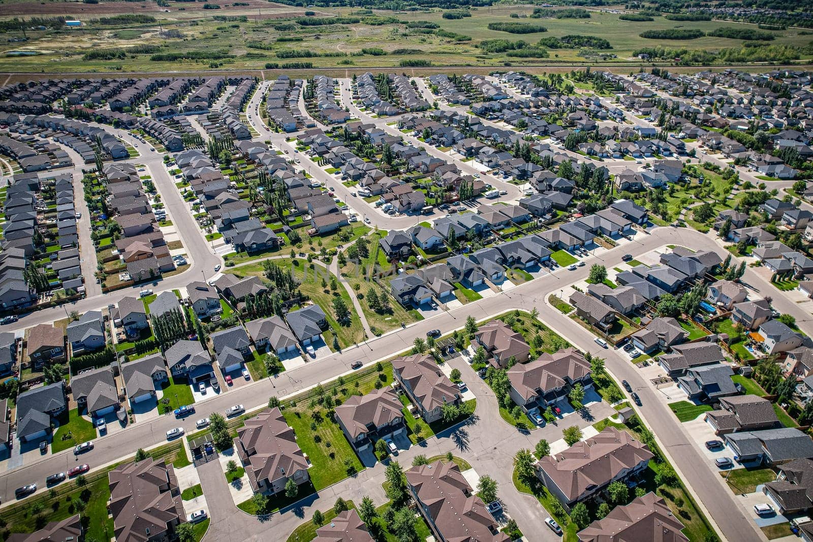 Captivating aerial shot of Stonebridge in Saskatoon, highlighting the harmonious blend of modern architecture and Saskatchewan's verdant surroundings.