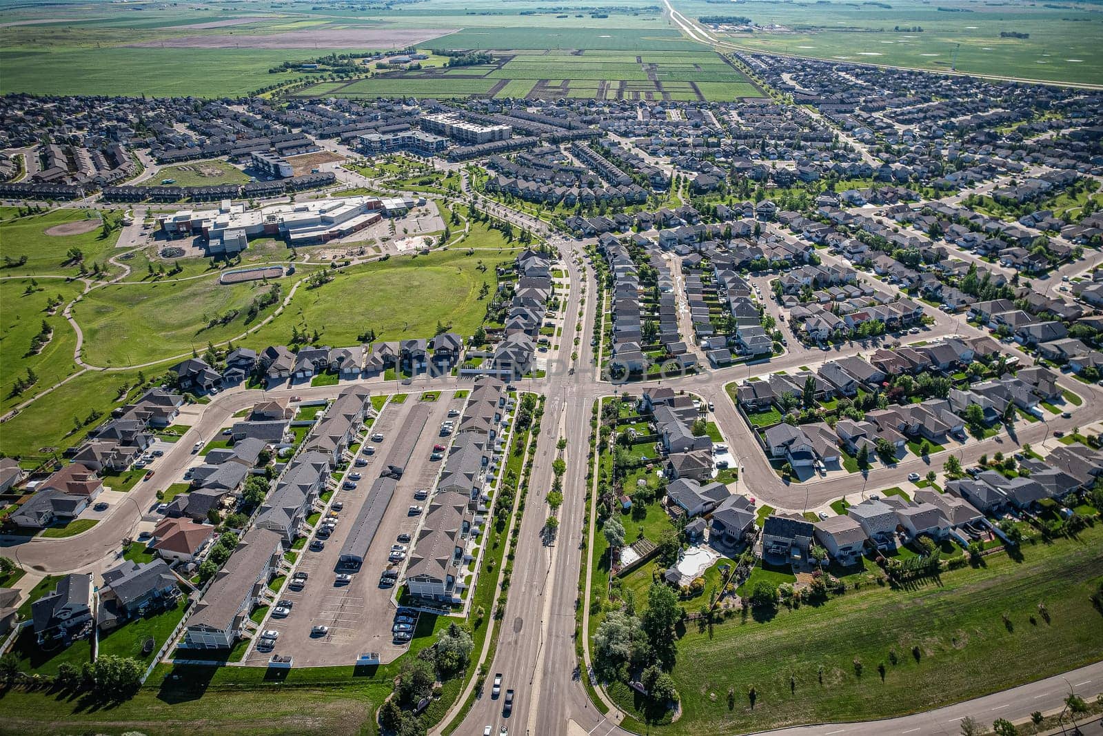 Elevated panorama of Willowgrove, showcasing the neighborhood's modern aesthetics intertwined with pockets of lush green, epitomizing Saskatoon's suburban beauty