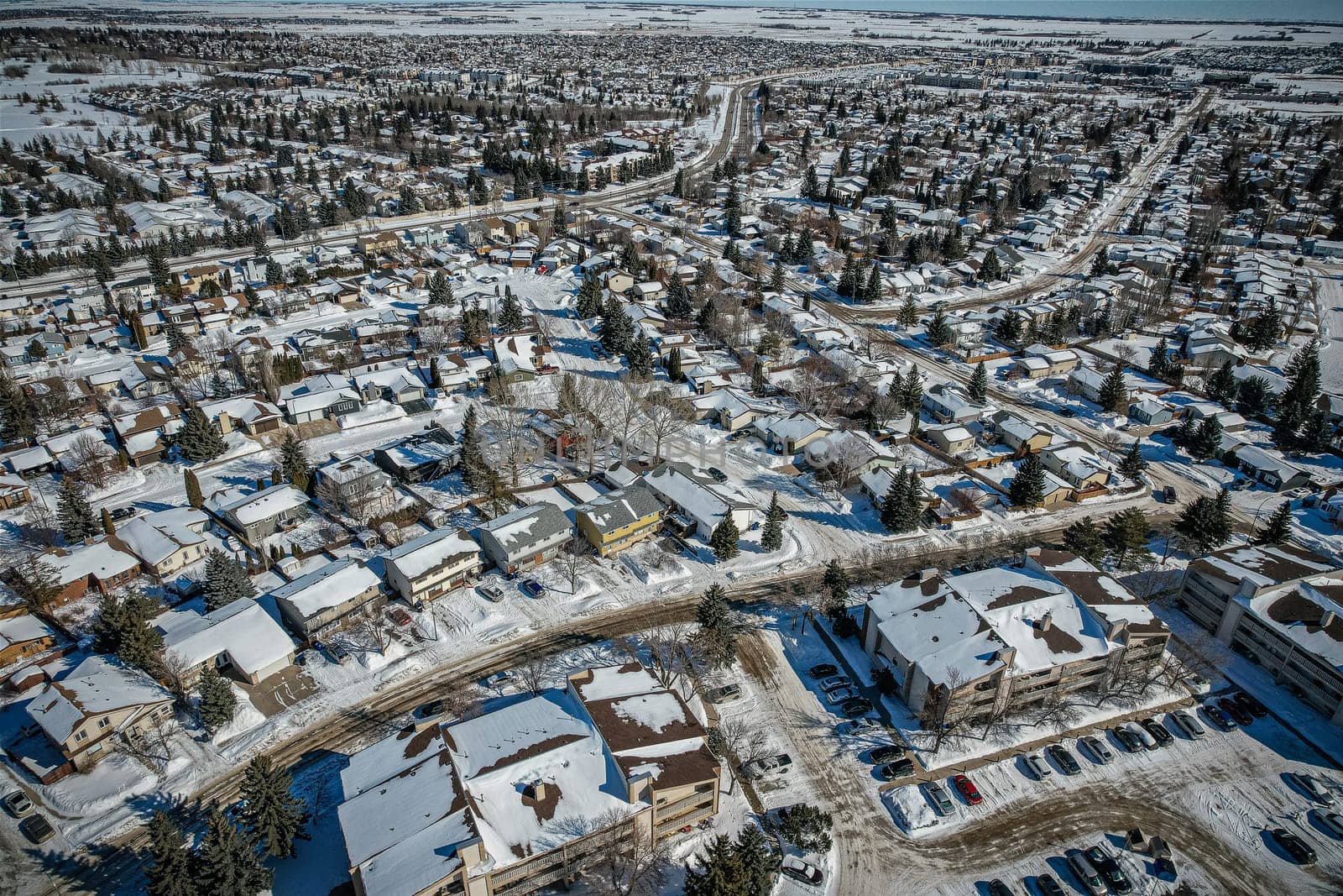 Soaring over Lakeview in Saskatoon, this bird's-eye capture magnifies the neighborhood's tranquil waters, verdant parks, and the serene rhythm of Saskatchewan living