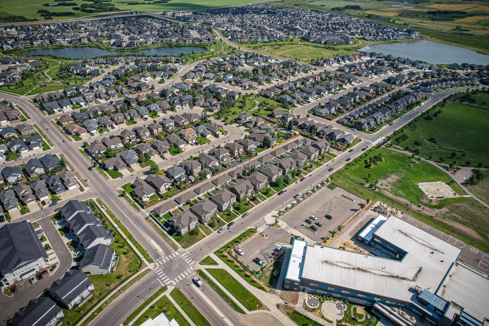 Captivating aerial shot of Stonebridge in Saskatoon, highlighting the harmonious blend of modern architecture and Saskatchewan's verdant surroundings.