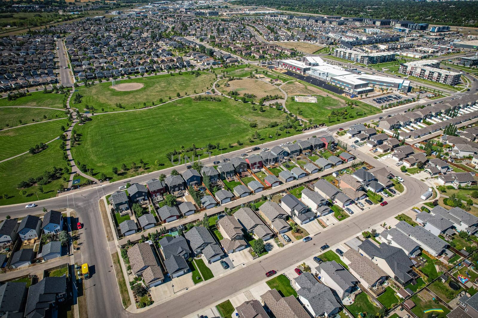Captivating aerial shot of Stonebridge in Saskatoon, highlighting the harmonious blend of modern architecture and Saskatchewan's verdant surroundings.