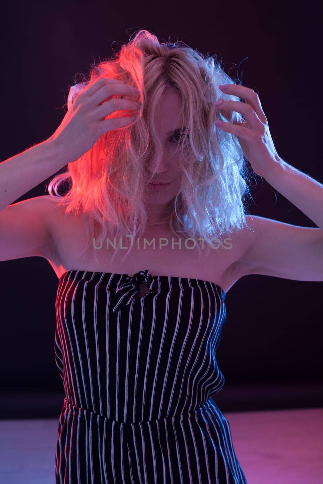 Beautiful fashionable blonde woman in striped clothes by Simakov