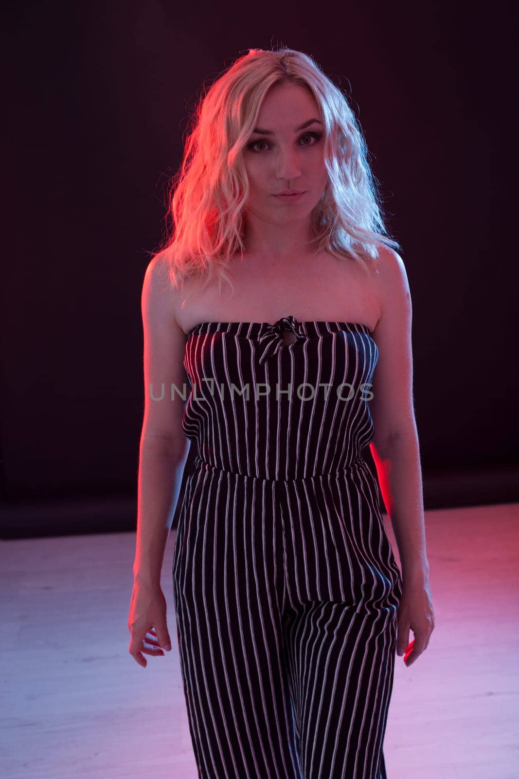 Beautiful fashionable blonde woman in striped clothes by Simakov