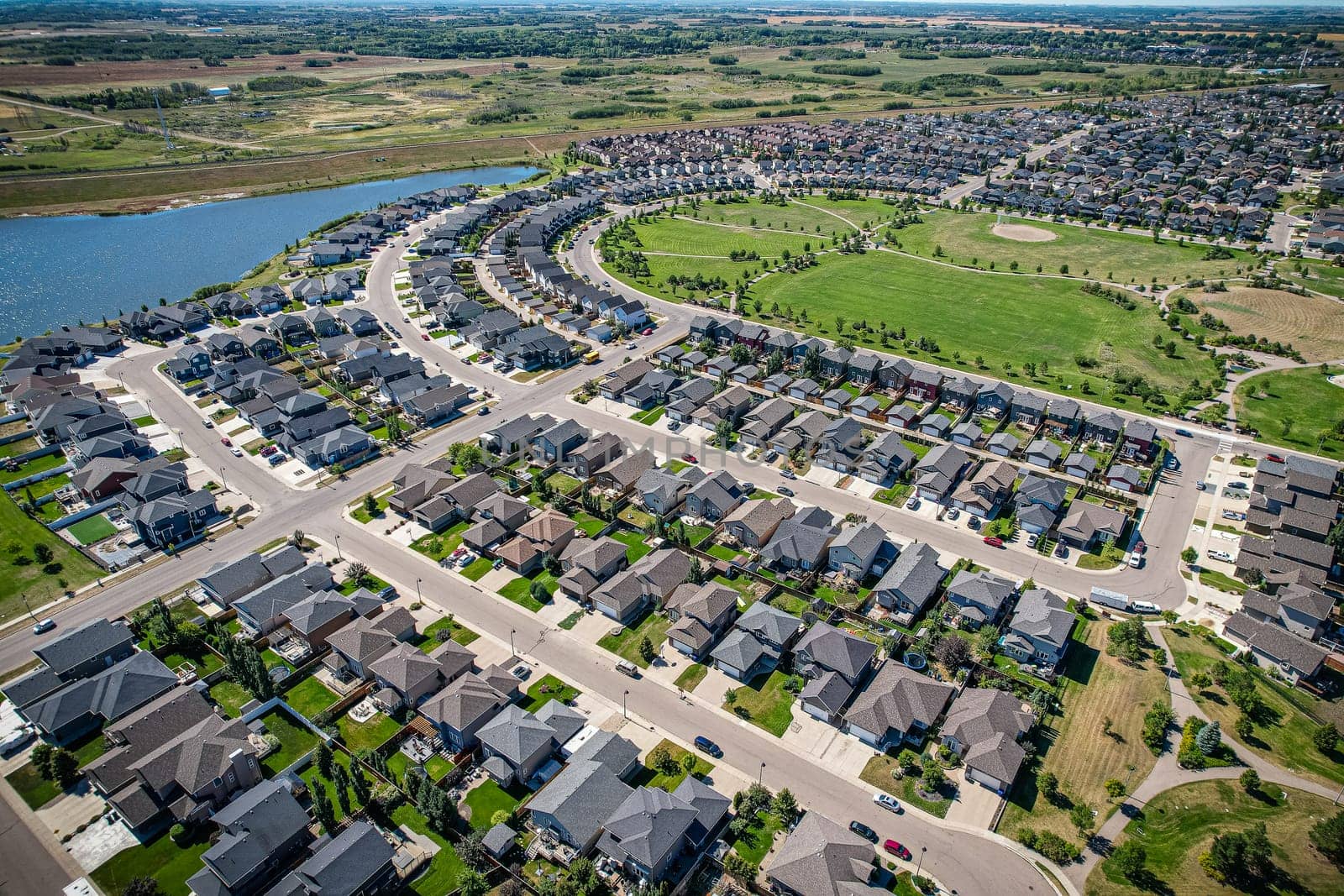 Captivating aerial shot of Stonebridge in Saskatoon, highlighting the harmonious blend of modern architecture and Saskatchewan's verdant surroundings.