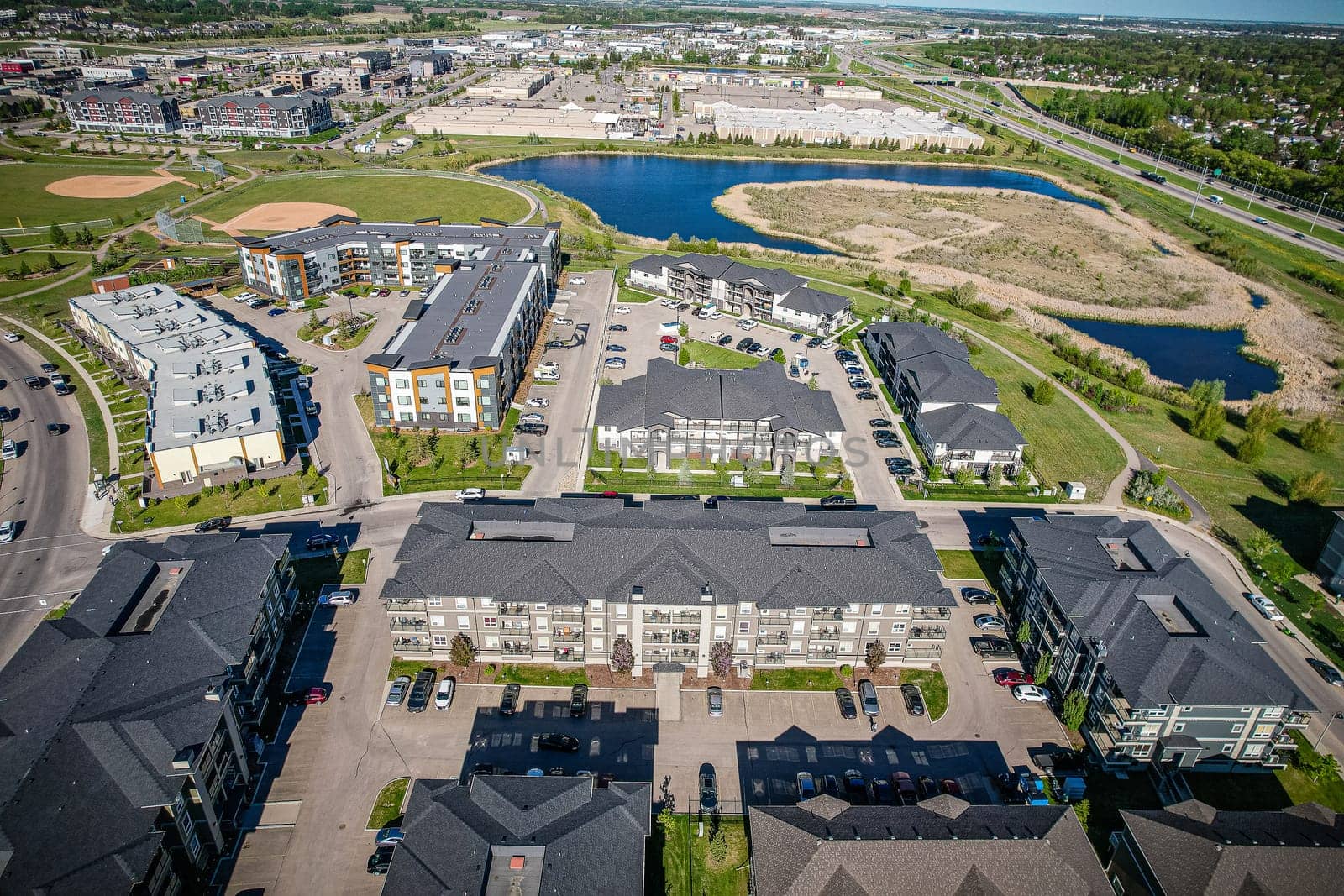 Captivating aerial shot of Stonebridge in Saskatoon, highlighting the harmonious blend of modern architecture and Saskatchewan's verdant surroundings.