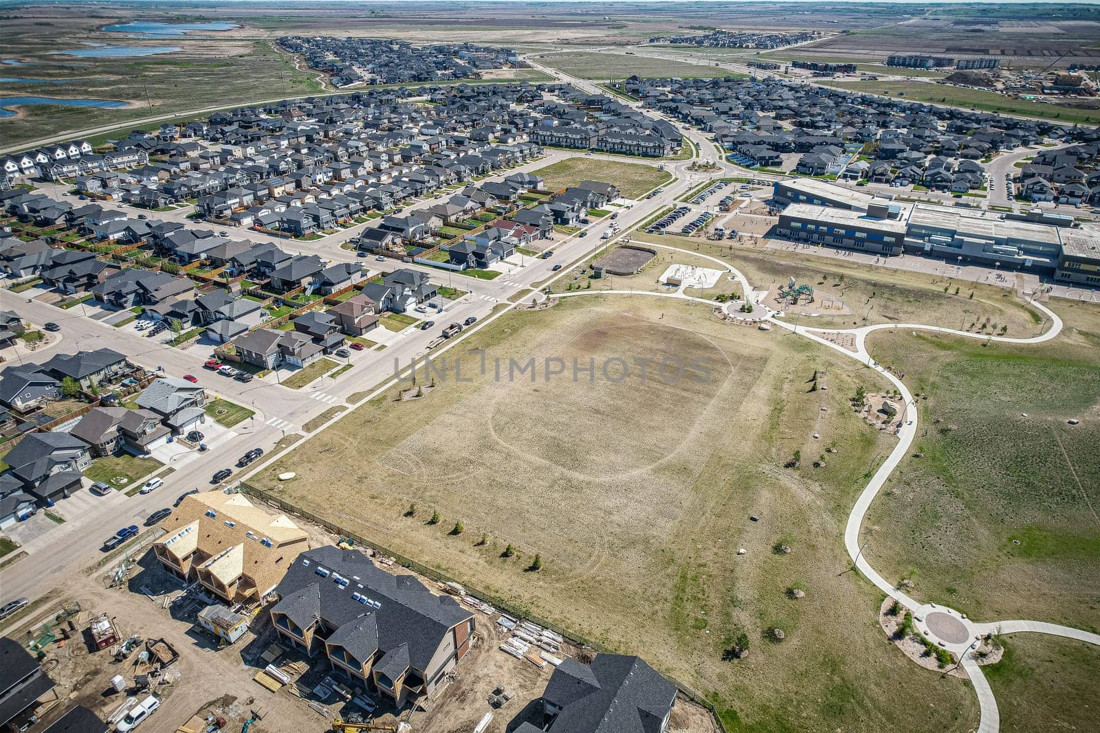 Stunning bird's-eye perspective of the Evergreen neighborhood in Saskatoon, showcasing the unique urban layout and the natural beauty of Saskatchewan's landscapes.