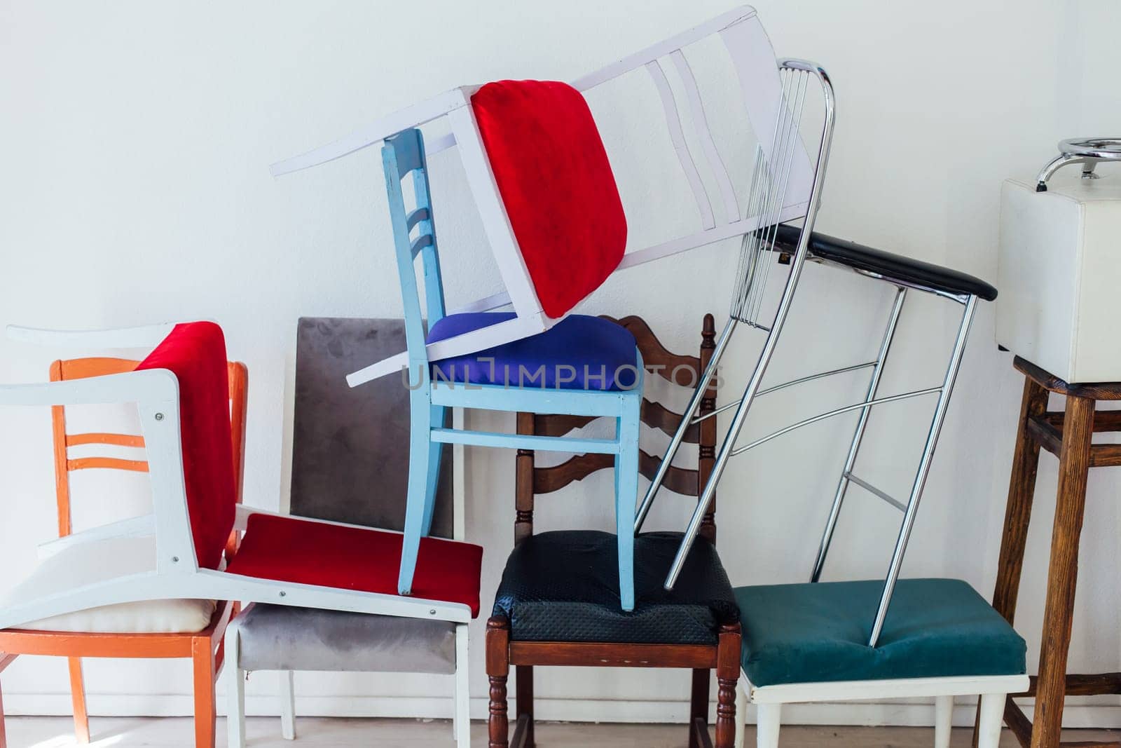 many multicolored chairs in the mess of the room