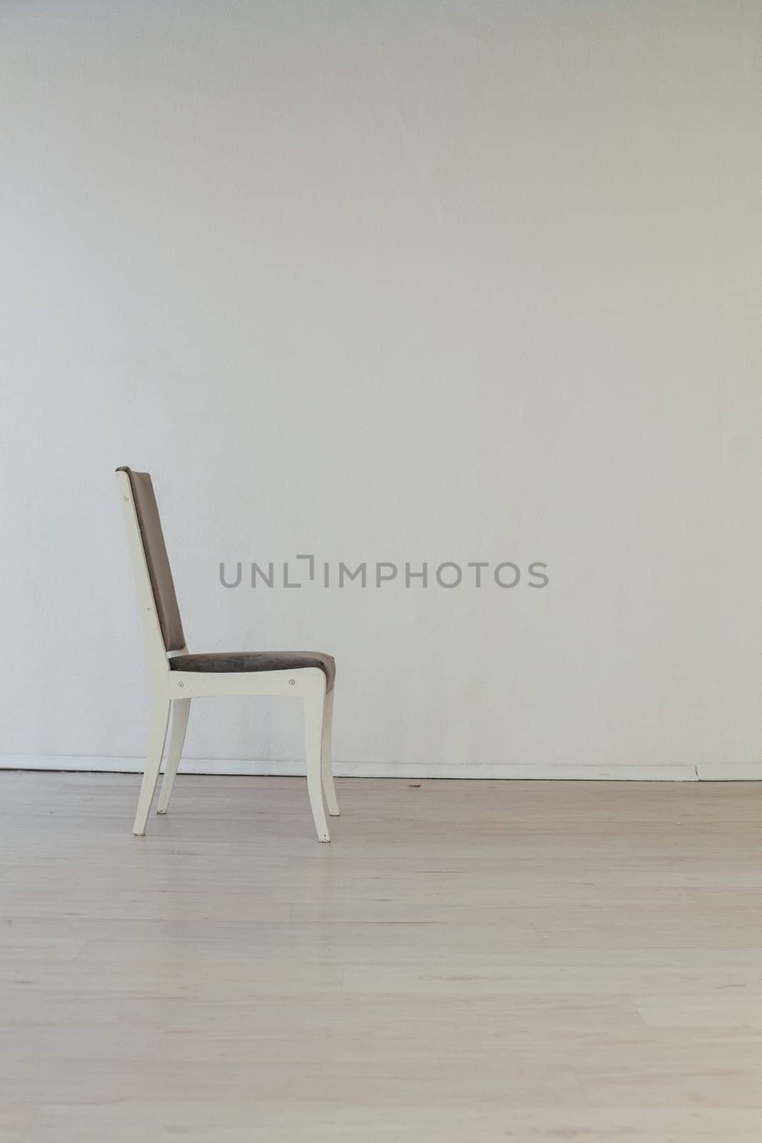 grey vintage chair in the interior of an empty white room by Simakov