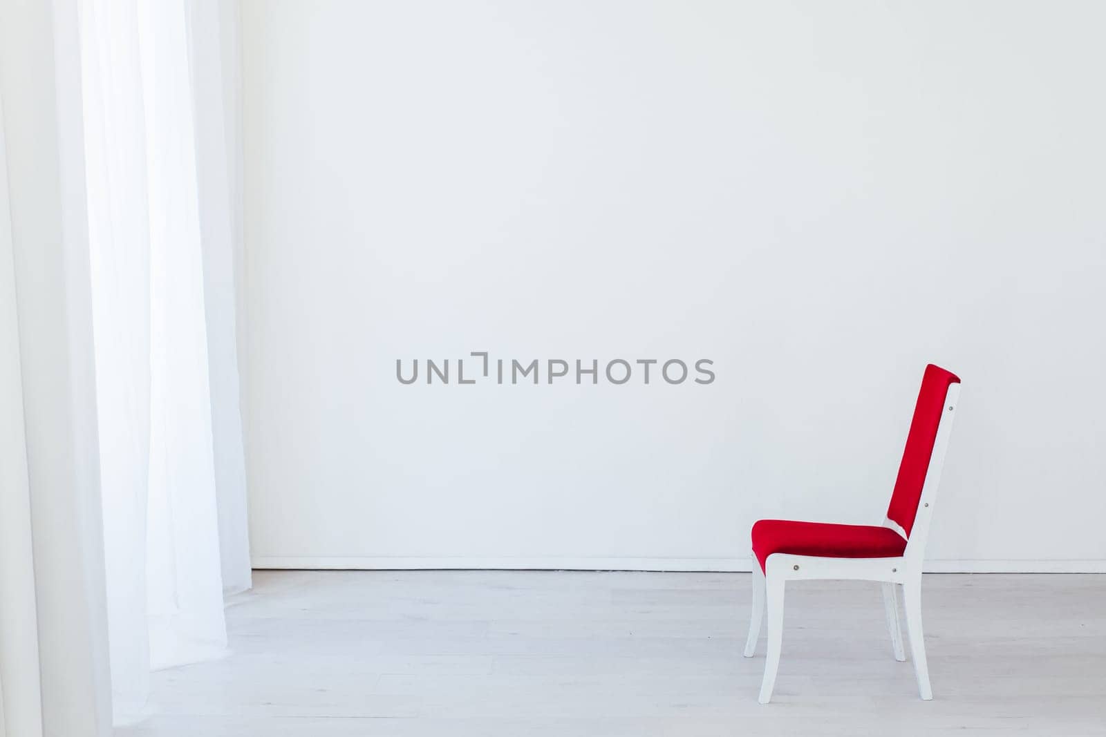 red vintage chair in the interior of an empty white room by Simakov