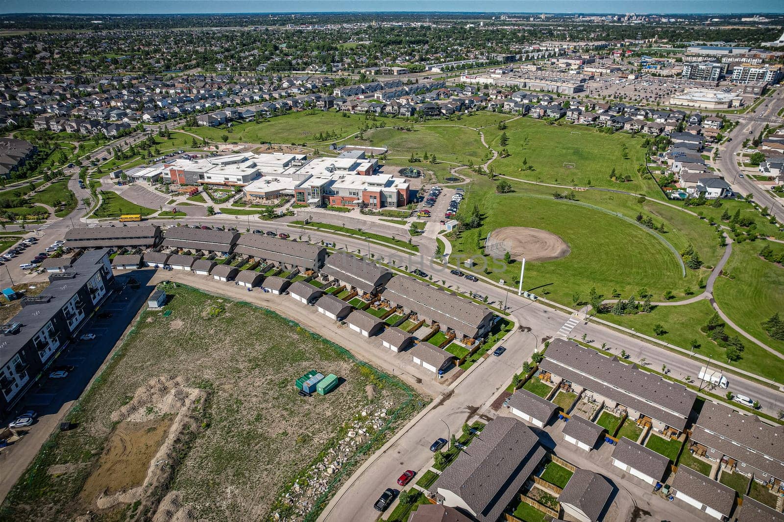 Elevated panorama of Willowgrove, showcasing the neighborhood's modern aesthetics intertwined with pockets of lush green, epitomizing Saskatoon's suburban beauty