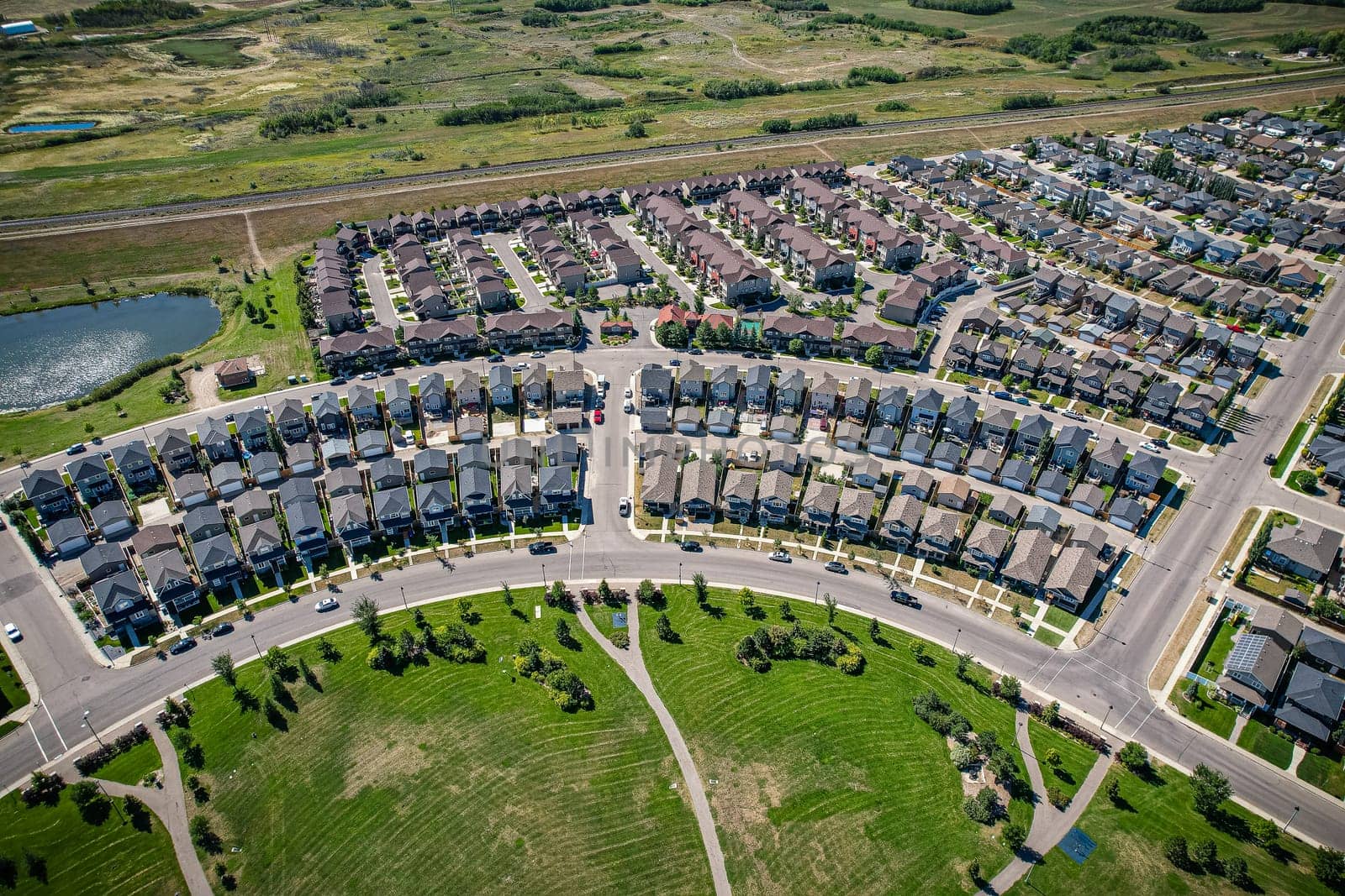 Captivating aerial shot of Stonebridge in Saskatoon, highlighting the harmonious blend of modern architecture and Saskatchewan's verdant surroundings.