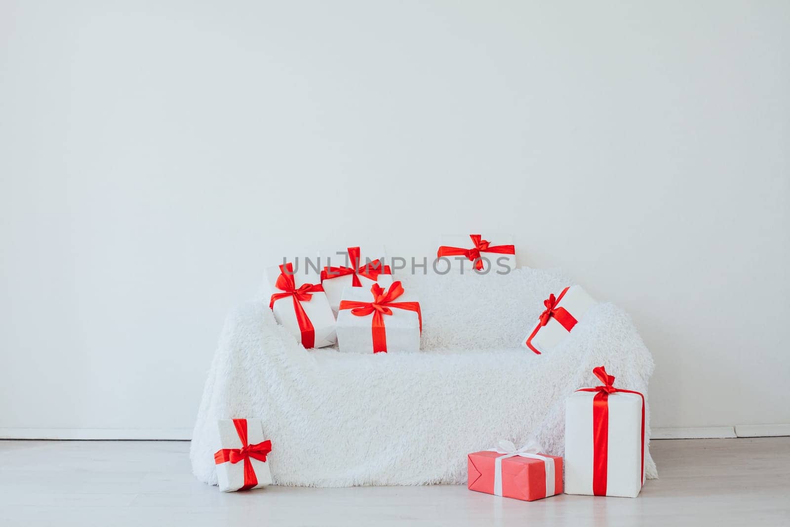 sofa with gifts in the interior of the white room