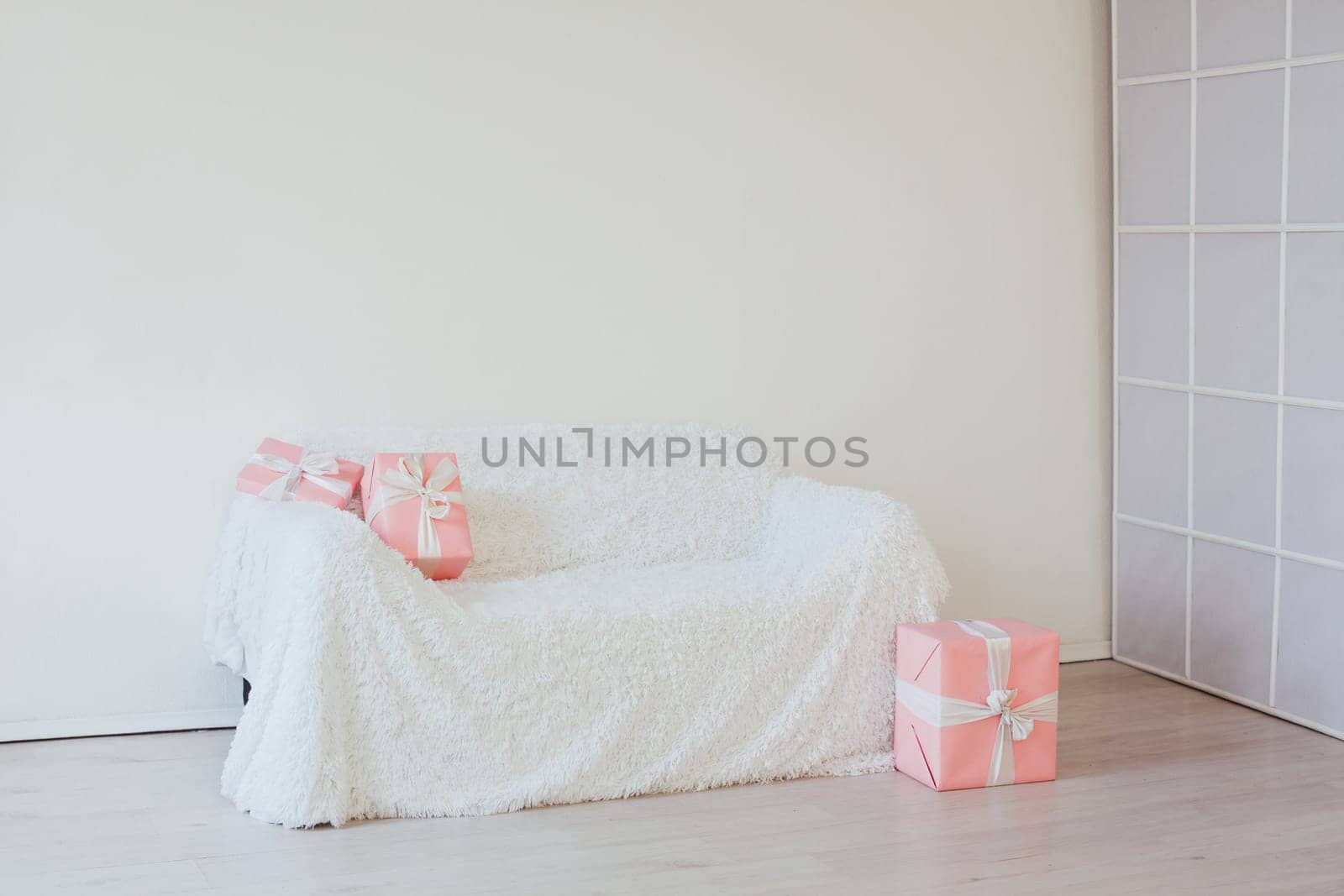 sofa with gifts in the interior of the white room