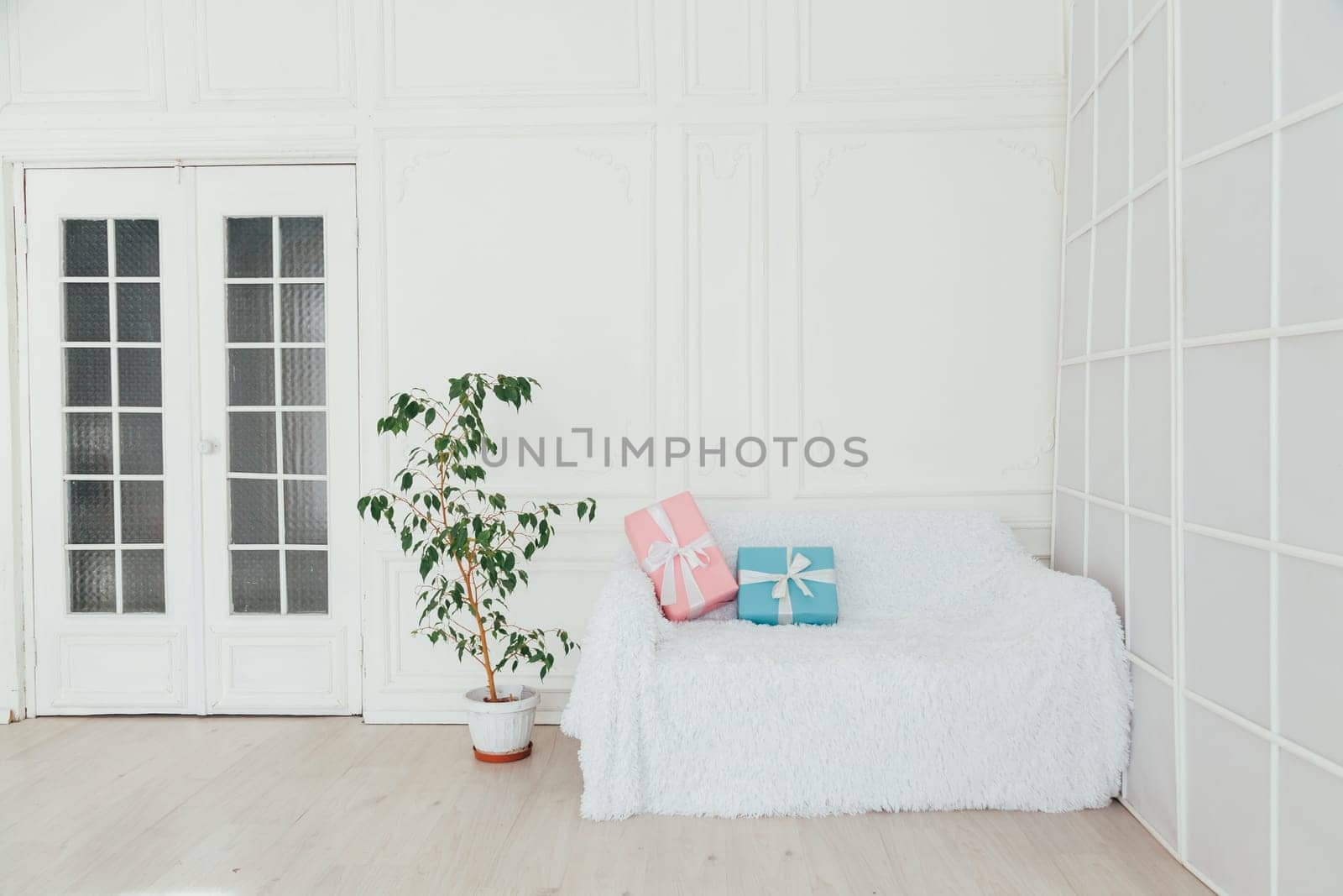 sofa with gifts in the interior of the white room