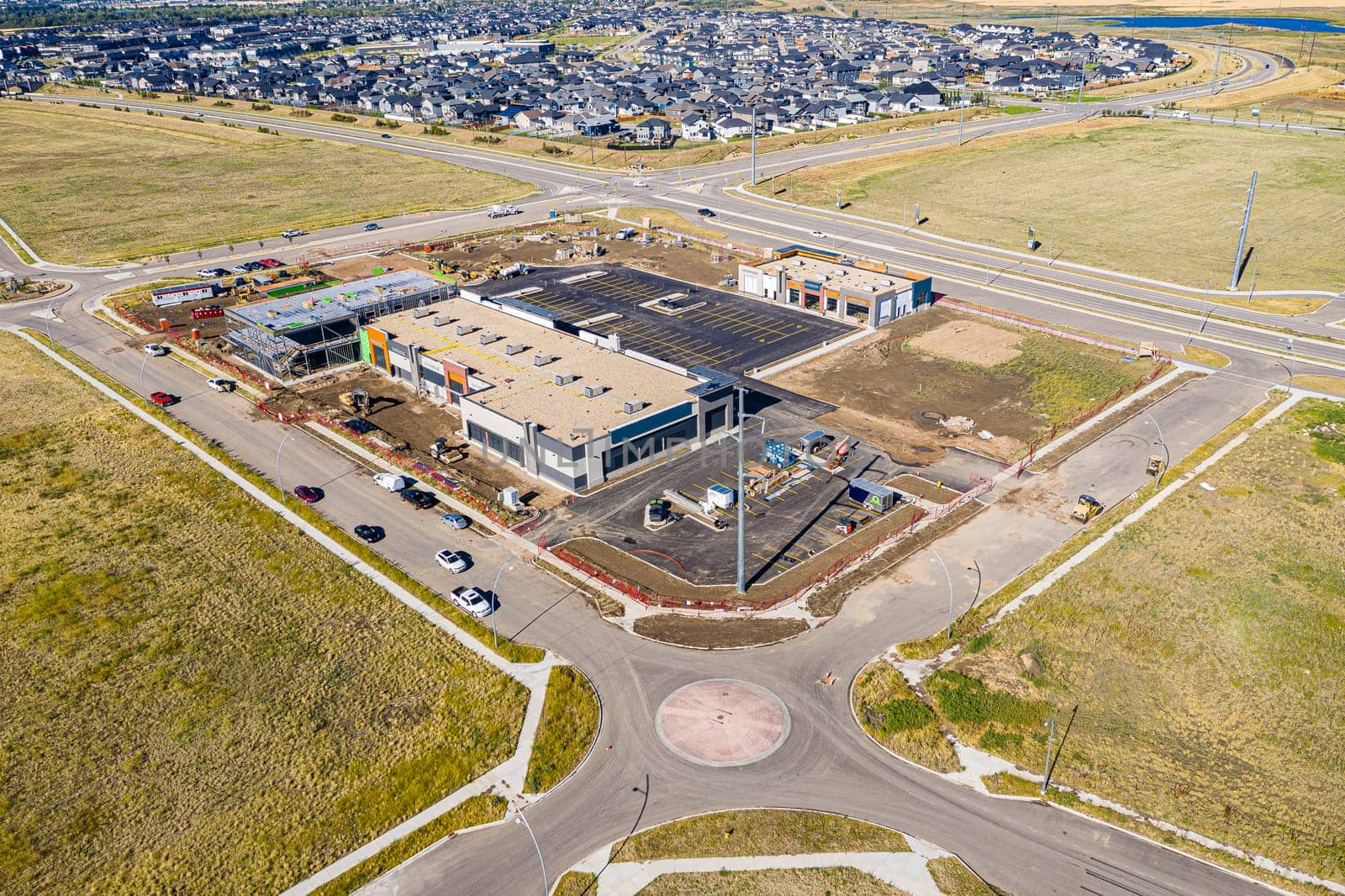 Aerial image of Evergreen, Saskatoon, SK, highlighting tree-lined streets, modern homes, and green spaces. A serene neighborhood portrait, ideal for real estate and urban planning.