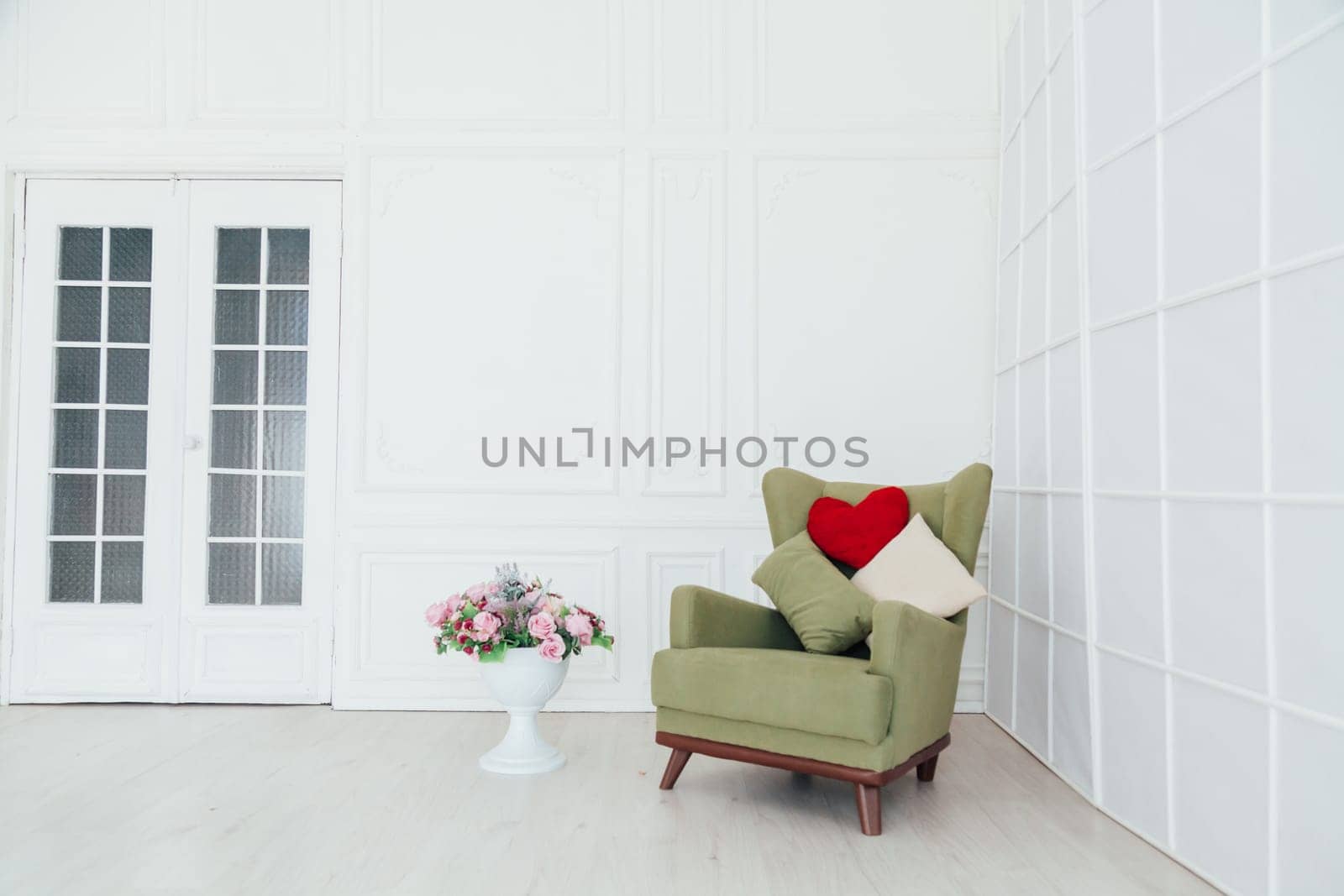 green vintage chair in the interior of the white room by Simakov