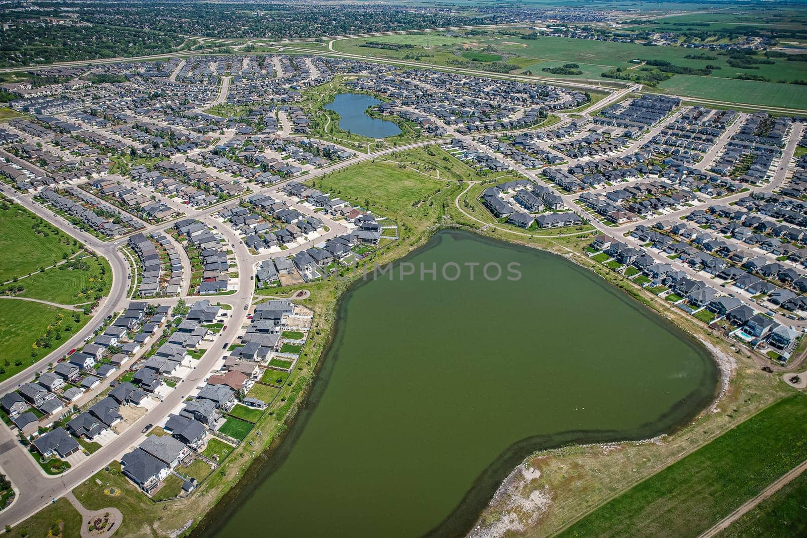 Captivating aerial shot of Stonebridge in Saskatoon, highlighting the harmonious blend of modern architecture and Saskatchewan's verdant surroundings.