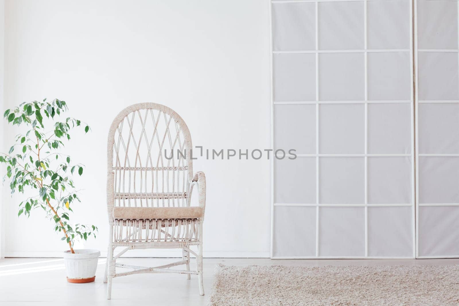white vintage chair in the interior of the white room by Simakov
