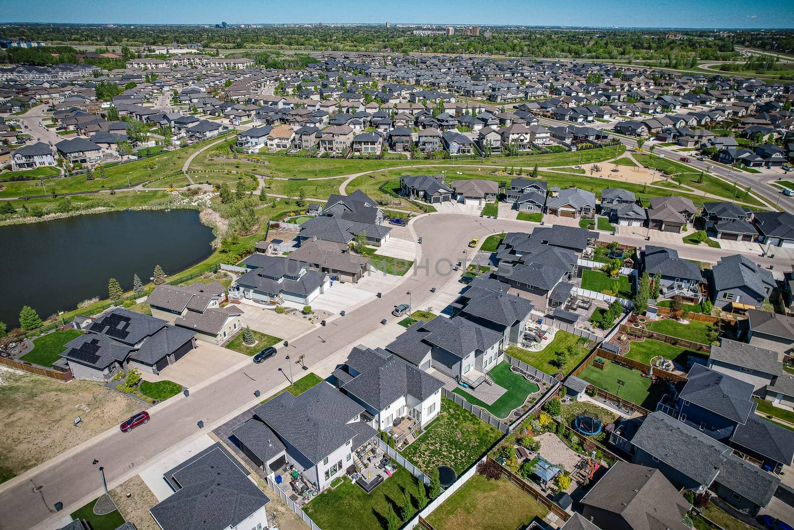 Captivating aerial shot of Stonebridge in Saskatoon, highlighting the harmonious blend of modern architecture and Saskatchewan's verdant surroundings.