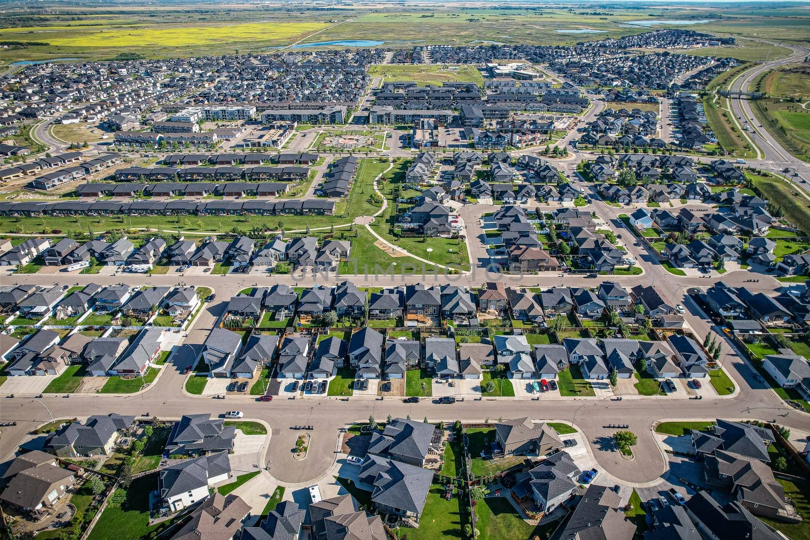 Elevated panorama of Willowgrove, showcasing the neighborhood's modern aesthetics intertwined with pockets of lush green, epitomizing Saskatoon's suburban beauty