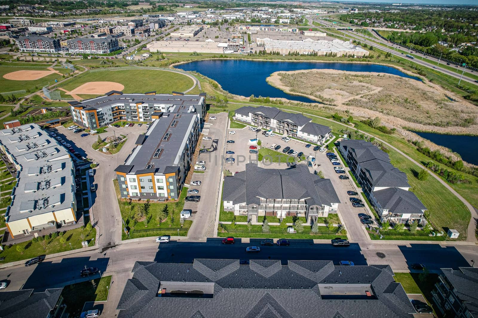 Captivating aerial shot of Stonebridge in Saskatoon, highlighting the harmonious blend of modern architecture and Saskatchewan's verdant surroundings.