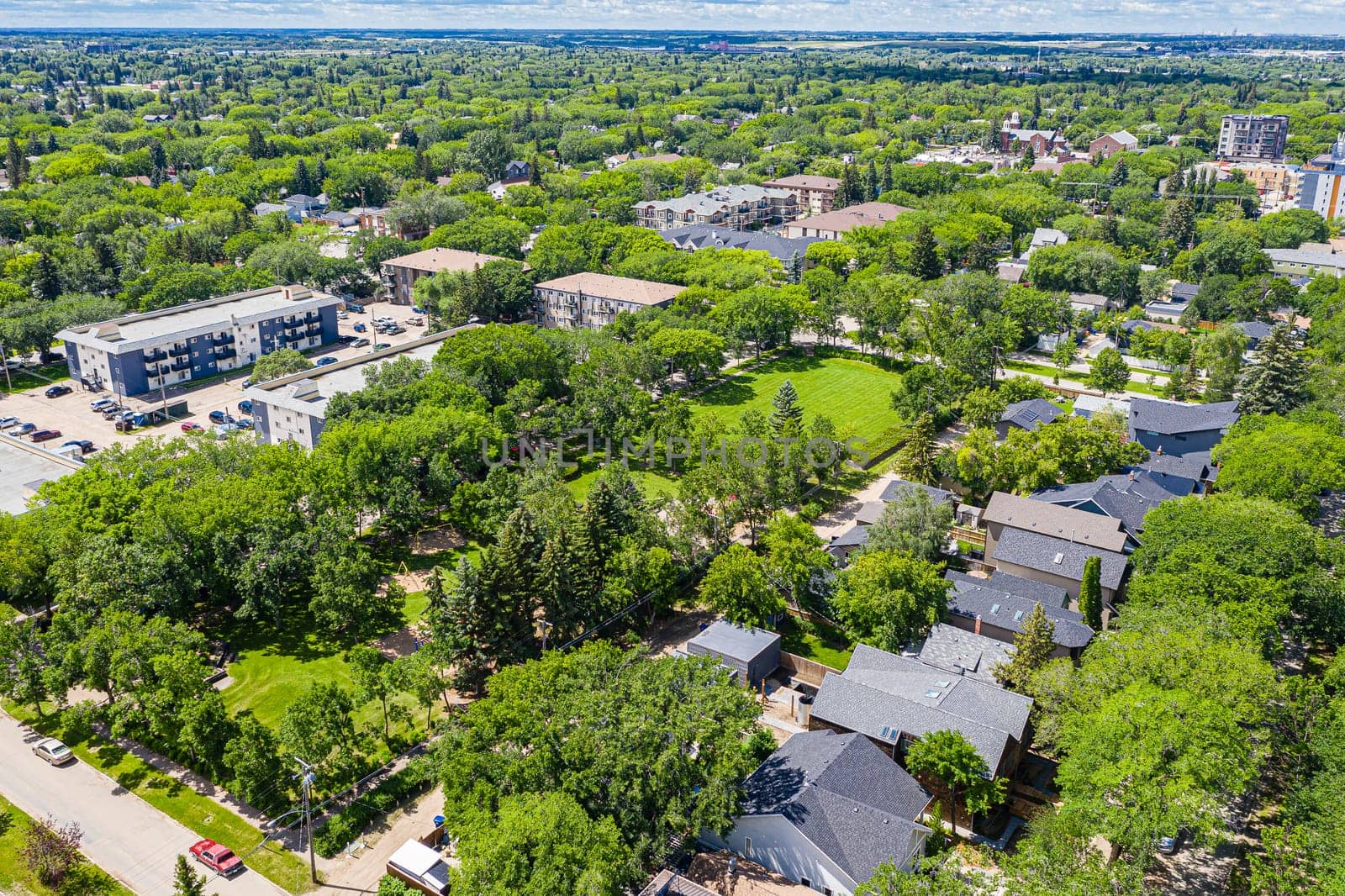 Ascend above Varsity View, the Saskatoon neighborhood celebrated for its proximity to university life. The drone image showcases a mix of residential areas, academic buildings, and lush parklands.