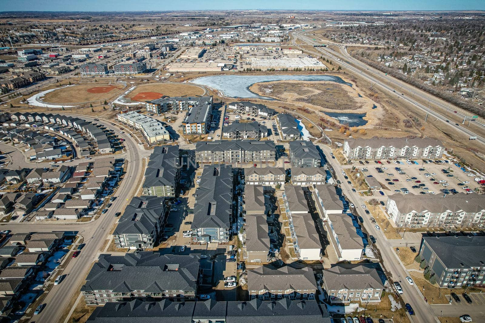Captivating aerial shot of Stonebridge in Saskatoon, highlighting the harmonious blend of modern architecture and Saskatchewan's verdant surroundings.