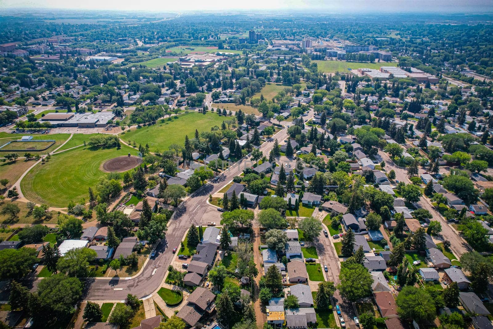 Aerial view of Brevoort Park which is a primarily residential neighbourhood located in the southeast part of Saskatoon, Saskatchewan, Canada. It includes part of the 8th Street business district. Just over half of its dwellings are single detached houses, with a sizeable minority of duplex or apartment-style multiple unit dwellings