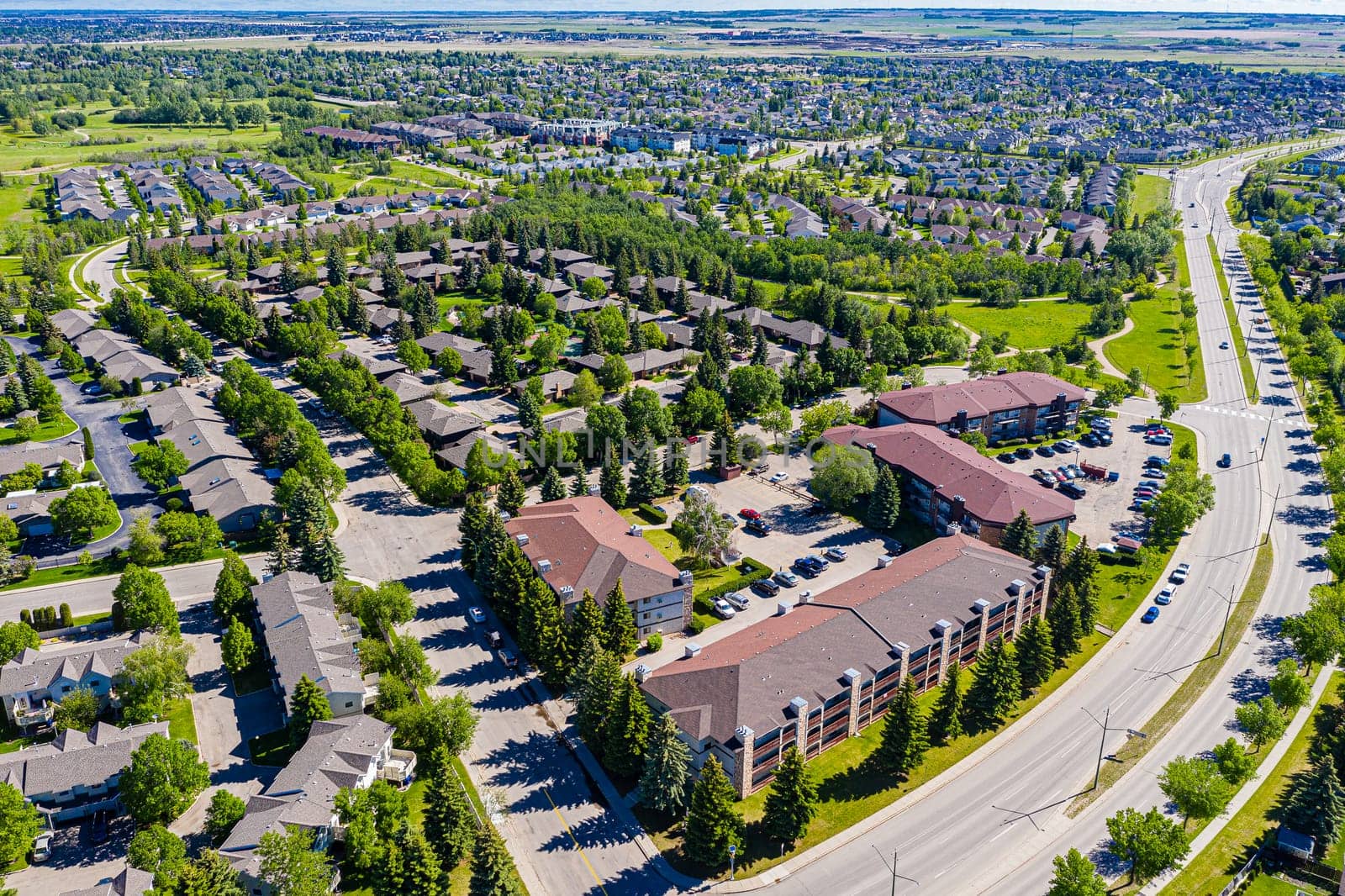 Aerial of Wildwood, Saskatoon, SK, highlighting its parks, diverse homes, and vibrant community life. A suburban haven reflecting harmonious living, perfect for real estate and urban design visuals.