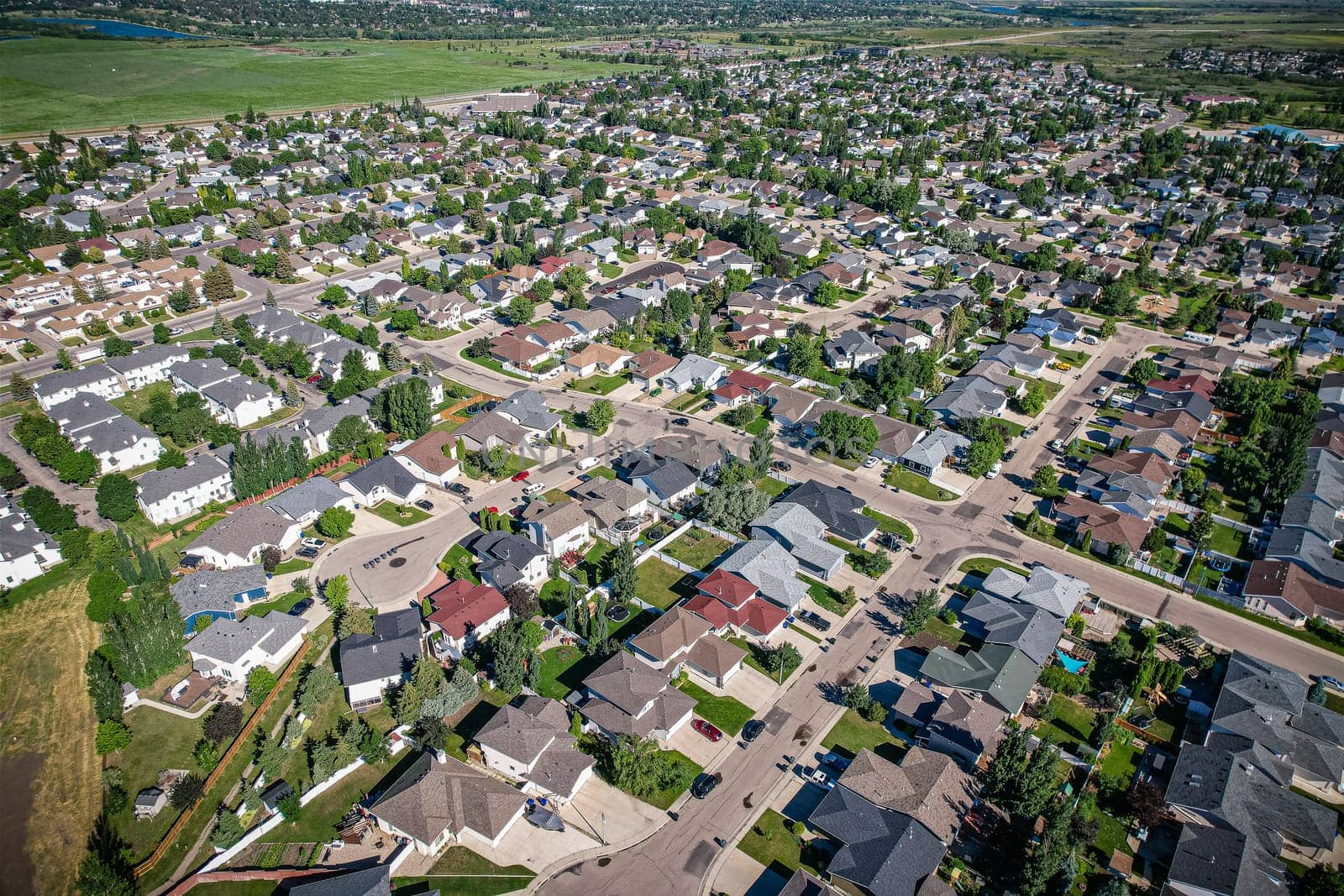 Aerial journey over Silverspring in Saskatoon, revealing a harmonious blend of suburban life, green expanses, and the distinct charm of Saskatchewan's landscapes.
