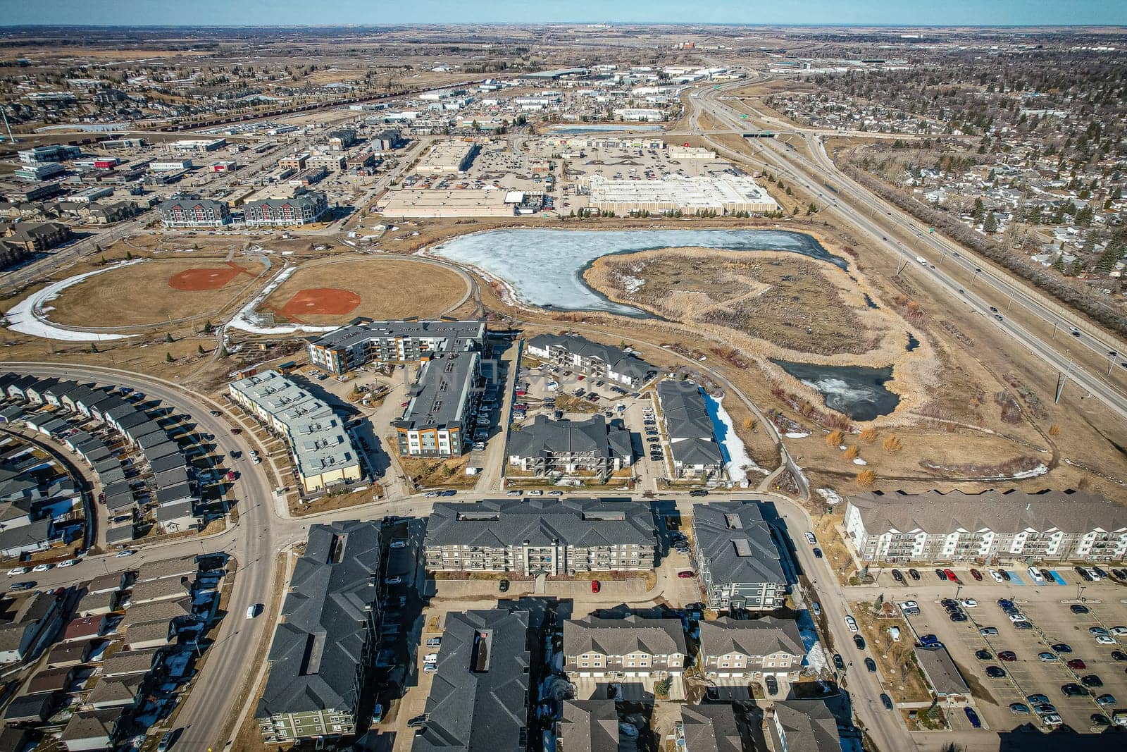 Captivating aerial shot of Stonebridge in Saskatoon, highlighting the harmonious blend of modern architecture and Saskatchewan's verdant surroundings.