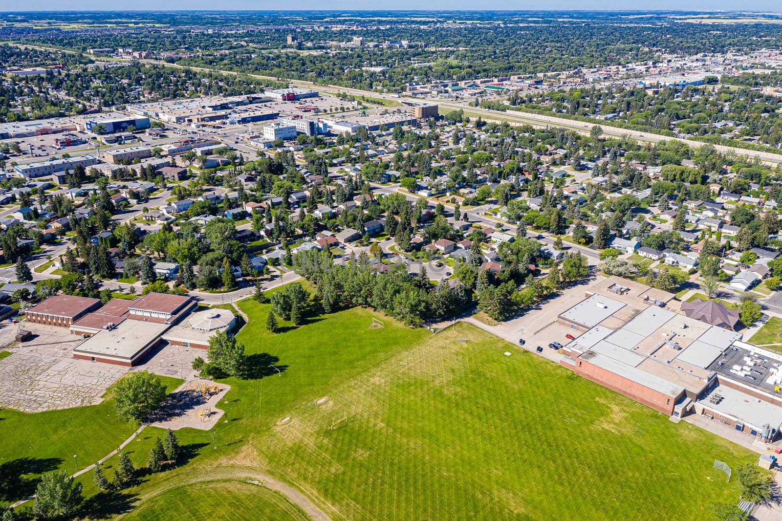 Explore College Park in Saskatoon from an aerial view. This drone image captures the neighborhood's blend of educational facilities, residential areas, and verdant parks, showcasing its dynamic urban fabric.