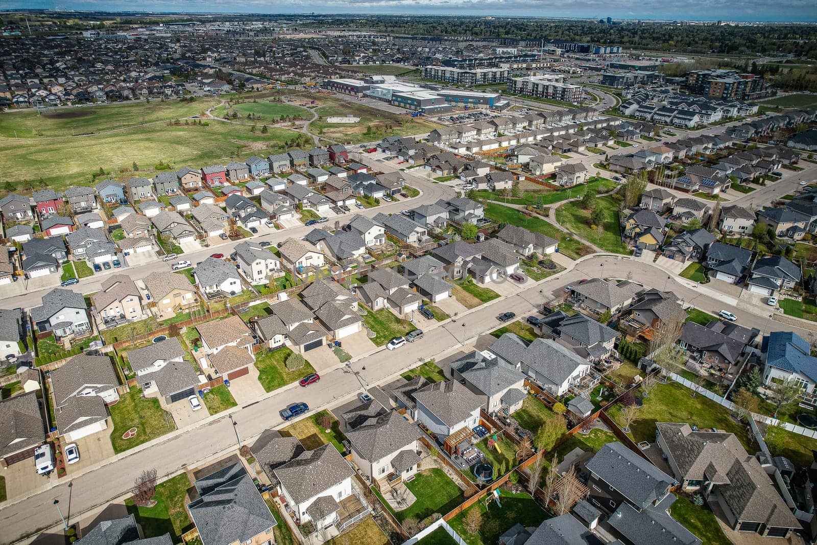 Captivating aerial shot of Stonebridge in Saskatoon, highlighting the harmonious blend of modern architecture and Saskatchewan's verdant surroundings.