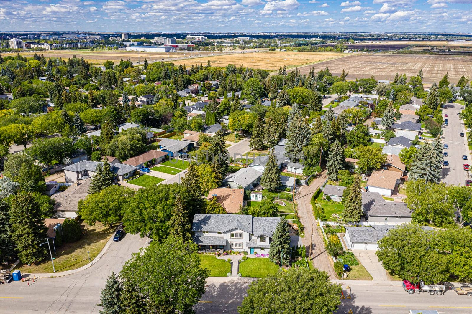 Experience the charm of Greystone Heights in Saskatoon from the sky. This drone image beautifully captures the neighborhood's serene streets, lush parks, and the cohesive community atmosphere.