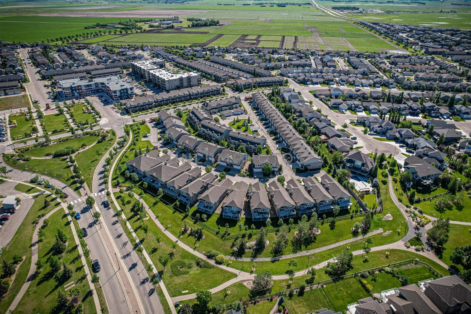 Elevated panorama of Willowgrove, showcasing the neighborhood's modern aesthetics intertwined with pockets of lush green, epitomizing Saskatoon's suburban beauty
