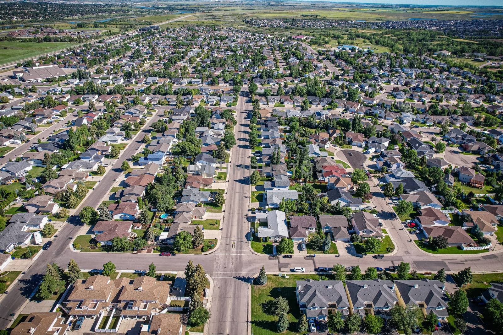 Aerial journey over Silverspring in Saskatoon, revealing a harmonious blend of suburban life, green expanses, and the distinct charm of Saskatchewan's landscapes.
