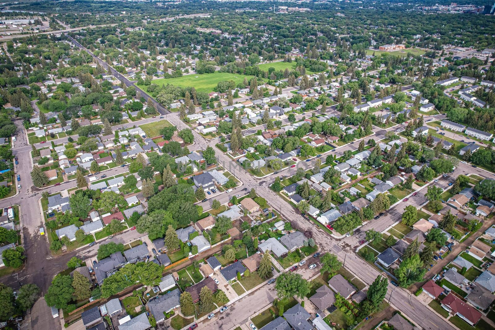 Stunning bird's-eye perspective of the Evergreen neighborhood in Saskatoon, showcasing the unique urban layout and the natural beauty of Saskatchewan's landscapes.