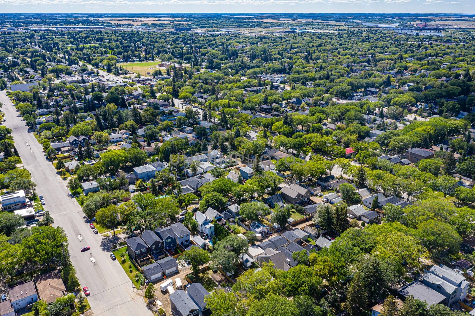 Explore the quaint Haultain neighborhood in Saskatoon from above. This drone image captures its charming streets, cozy homes, and the vibrant community spirit, all under the expansive prairie sky.