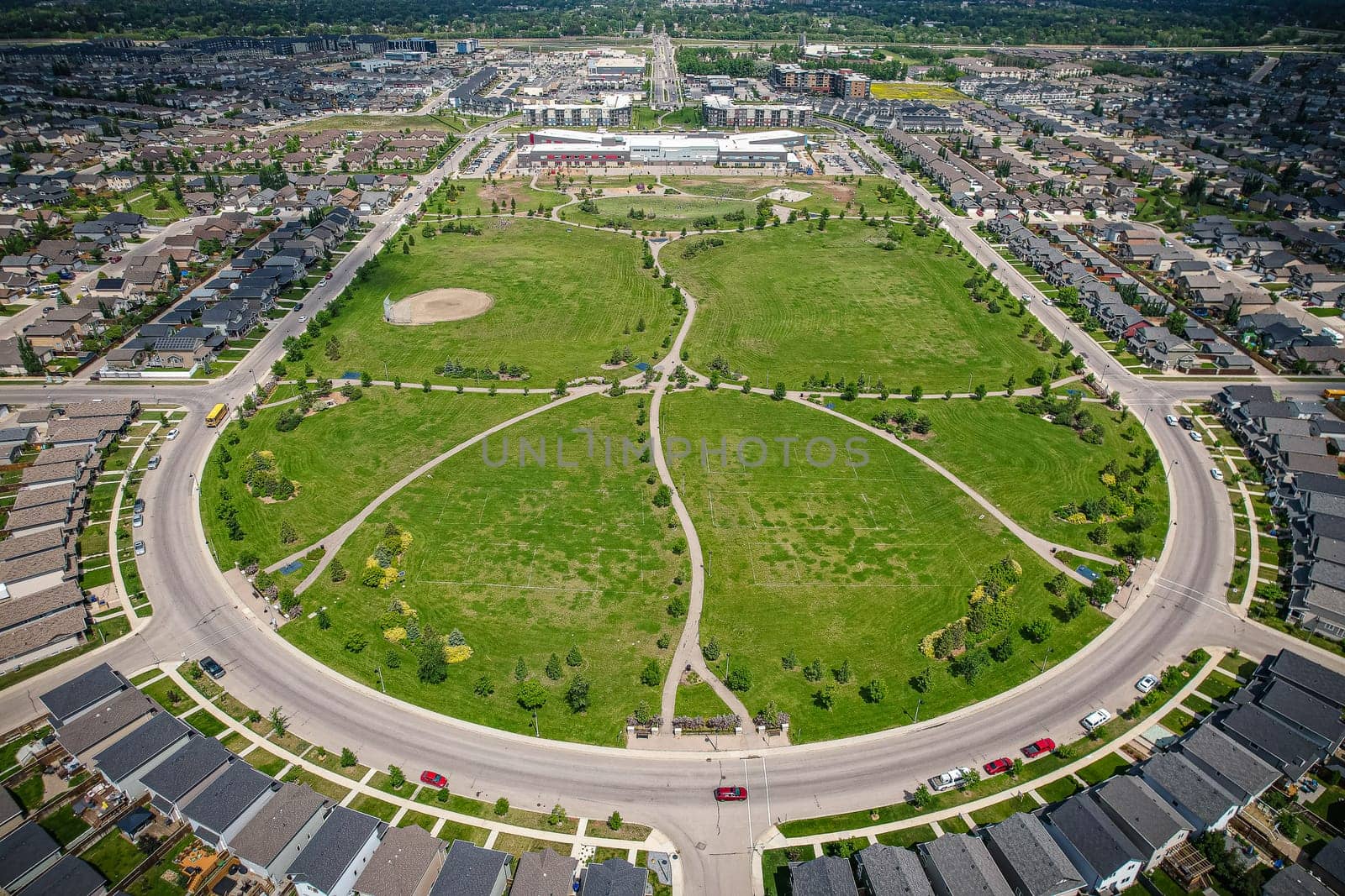 Captivating aerial shot of Stonebridge in Saskatoon, highlighting the harmonious blend of modern architecture and Saskatchewan's verdant surroundings.