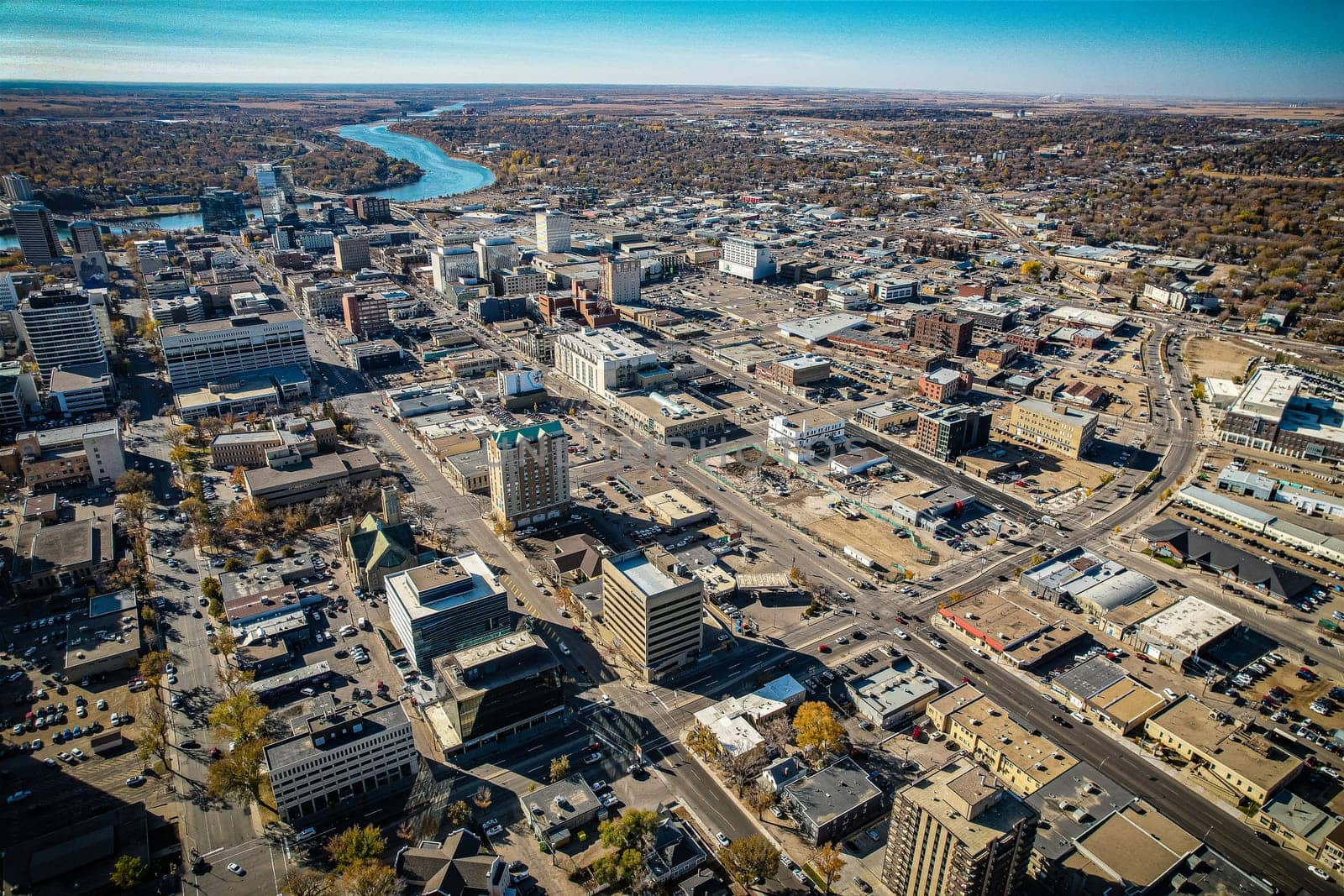 Aerial spectacle of downtown Saskatoon, revealing the city's architectural marvels, bustling streets, and the pulsating core of Saskatchewan's metropolis