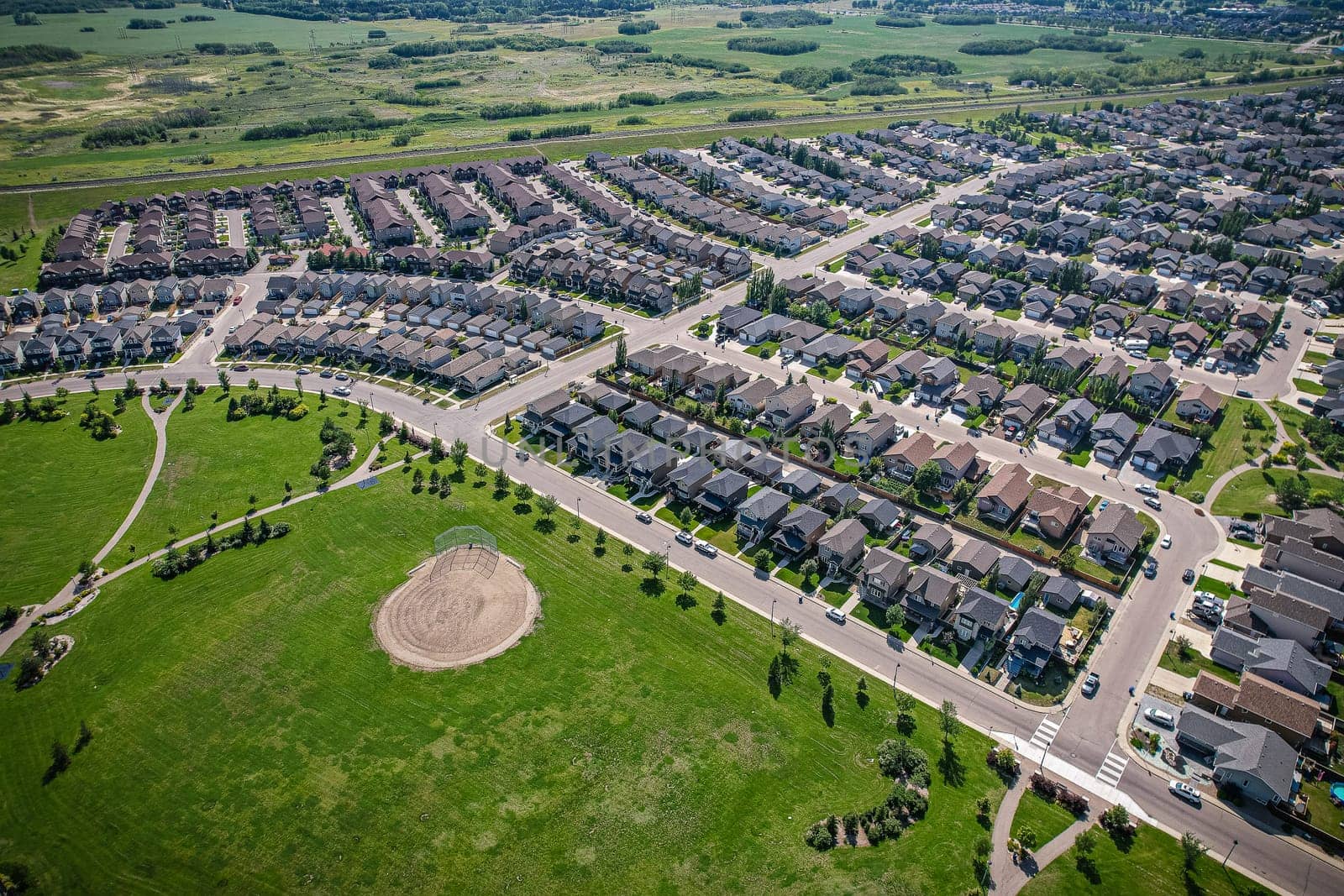 Captivating aerial shot of Stonebridge in Saskatoon, highlighting the harmonious blend of modern architecture and Saskatchewan's verdant surroundings.