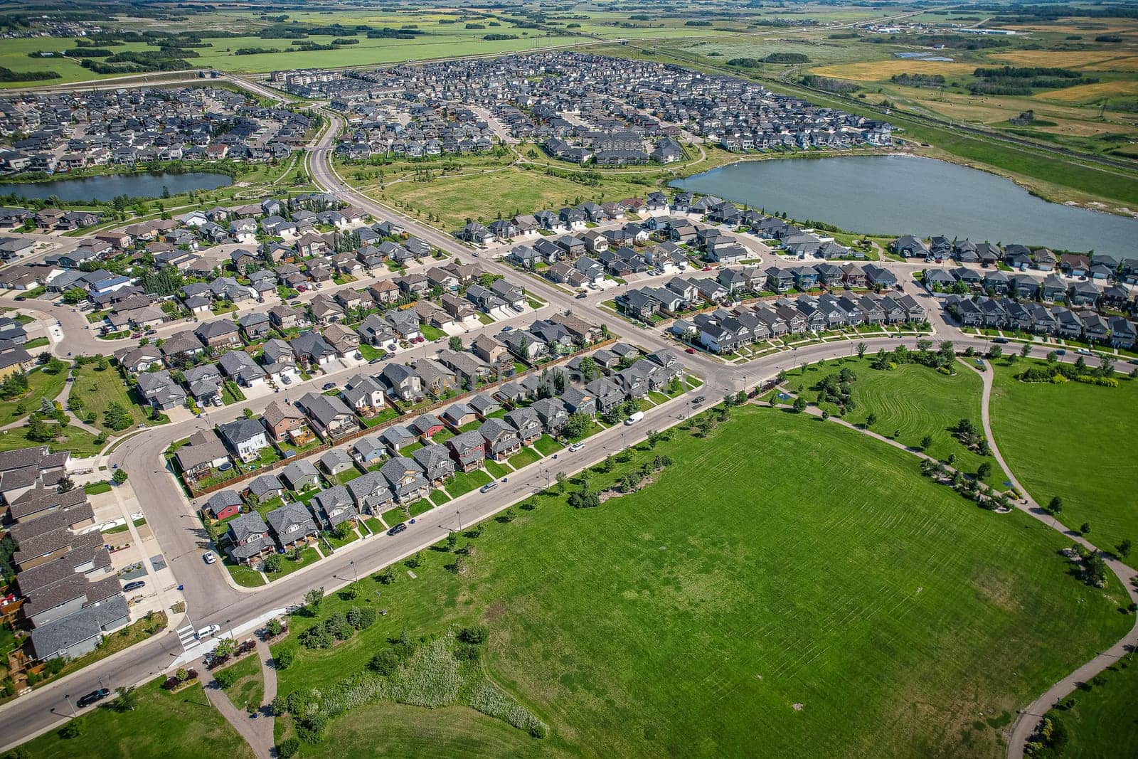 Captivating aerial shot of Stonebridge in Saskatoon, highlighting the harmonious blend of modern architecture and Saskatchewan's verdant surroundings.