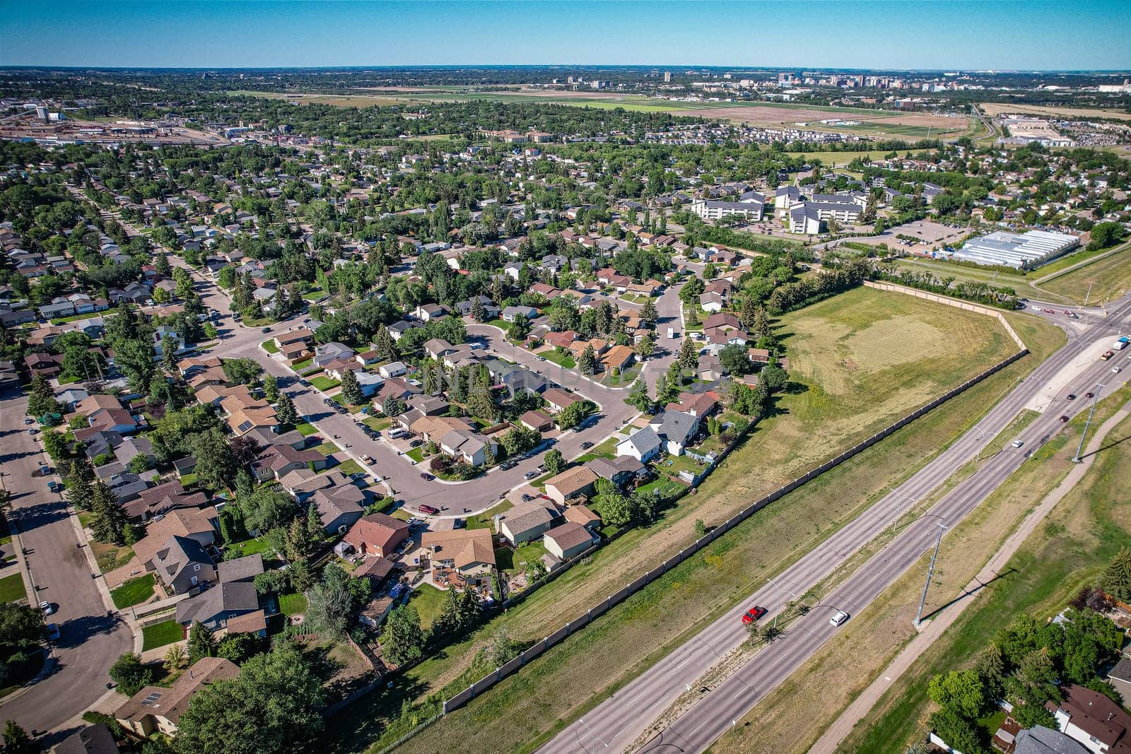 Aerial journey over Silverspring in Saskatoon, revealing a harmonious blend of suburban life, green expanses, and the distinct charm of Saskatchewan's landscapes.